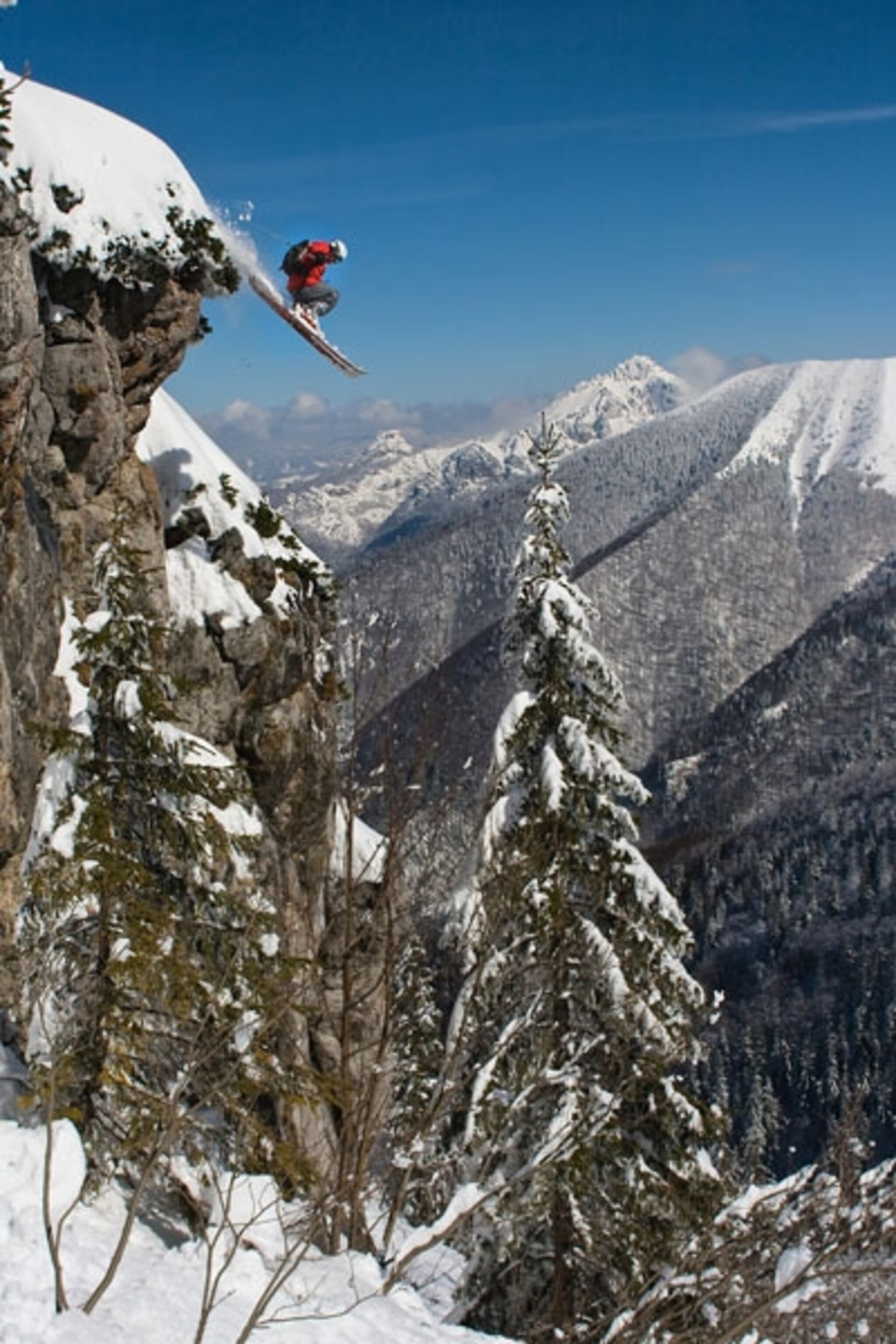 Skier jumping off a cliff