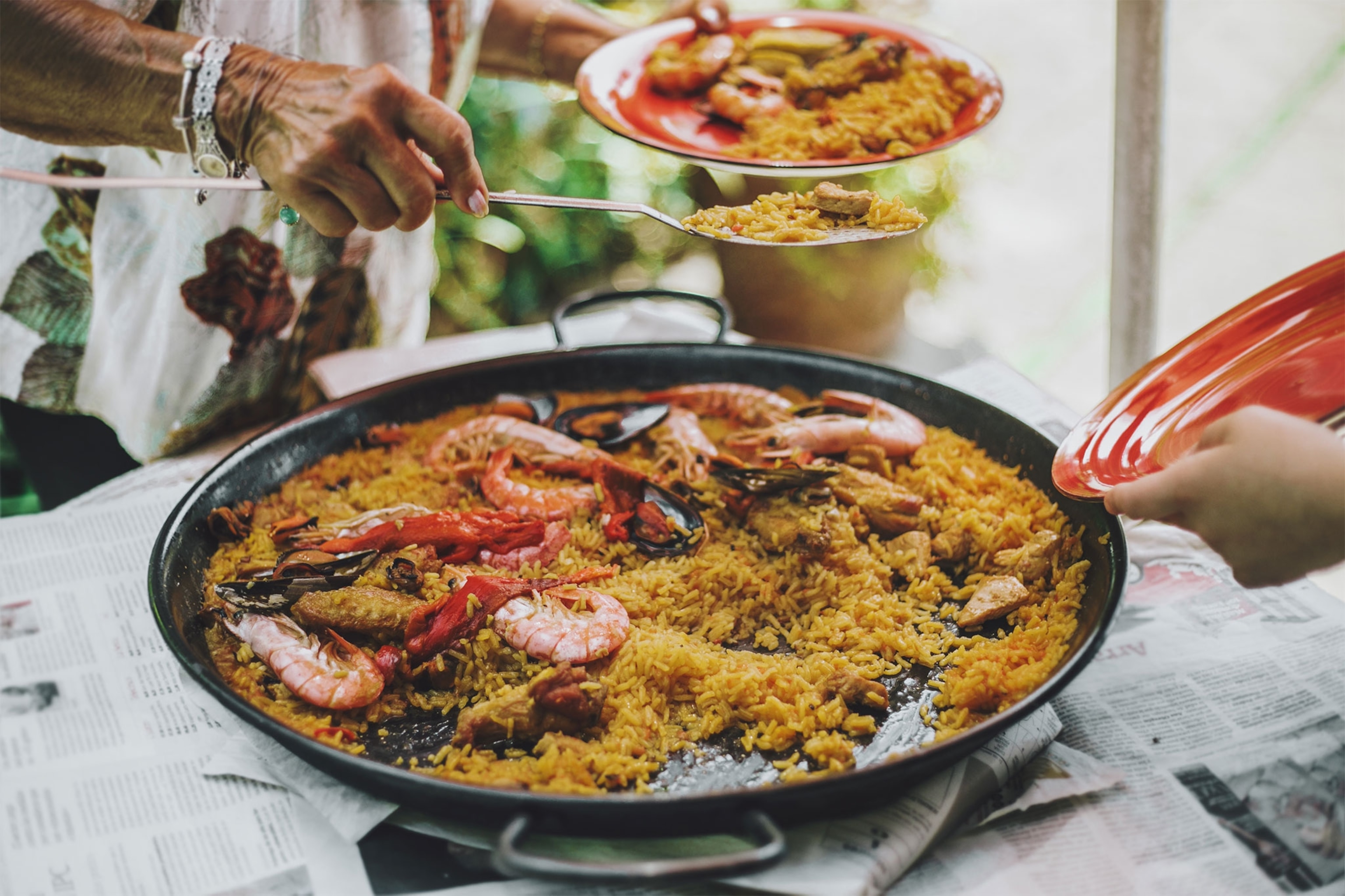 Person filling their plate with Valencia style paella