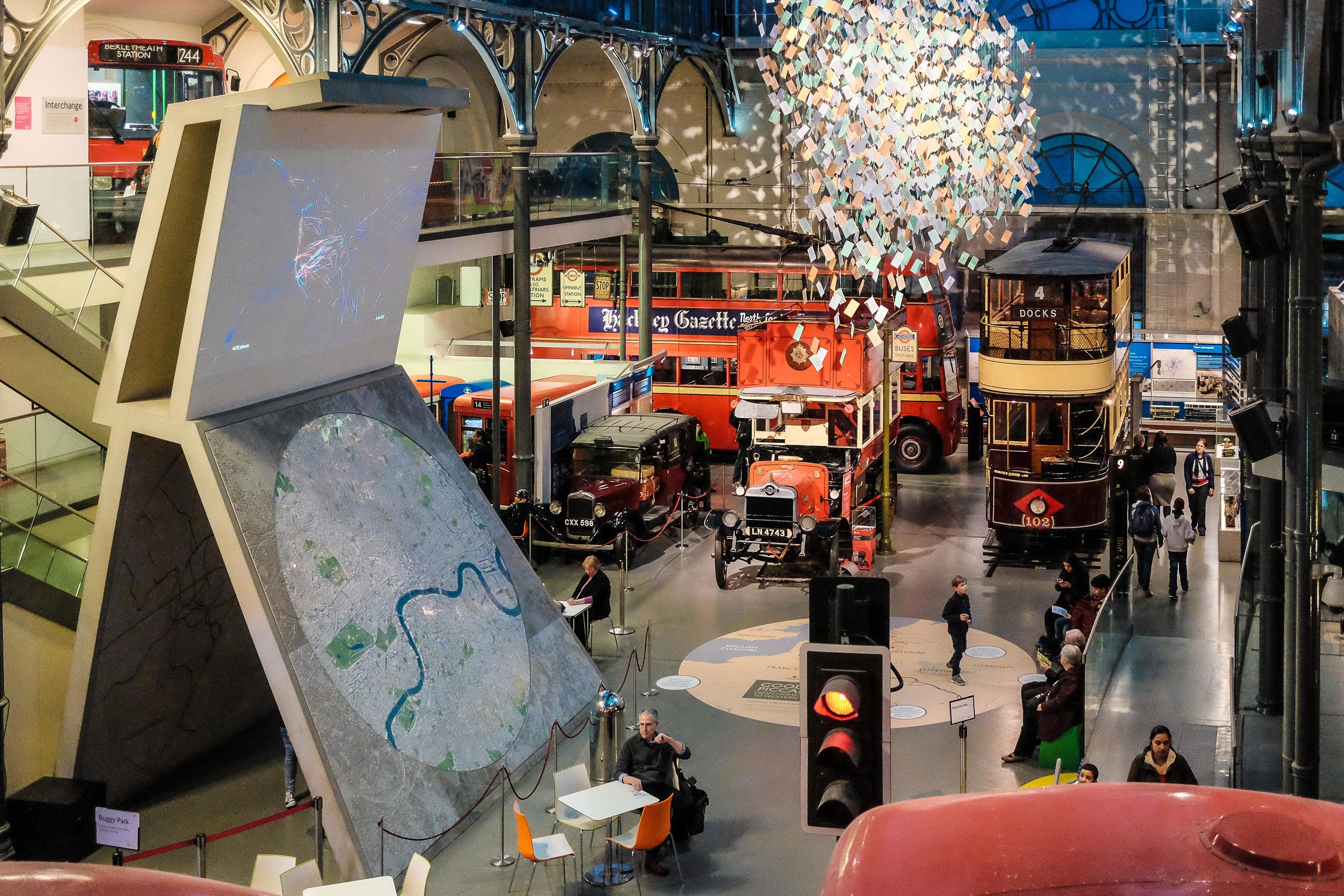 overhead shot of interior of museum, featuirng old bus and vehicles
