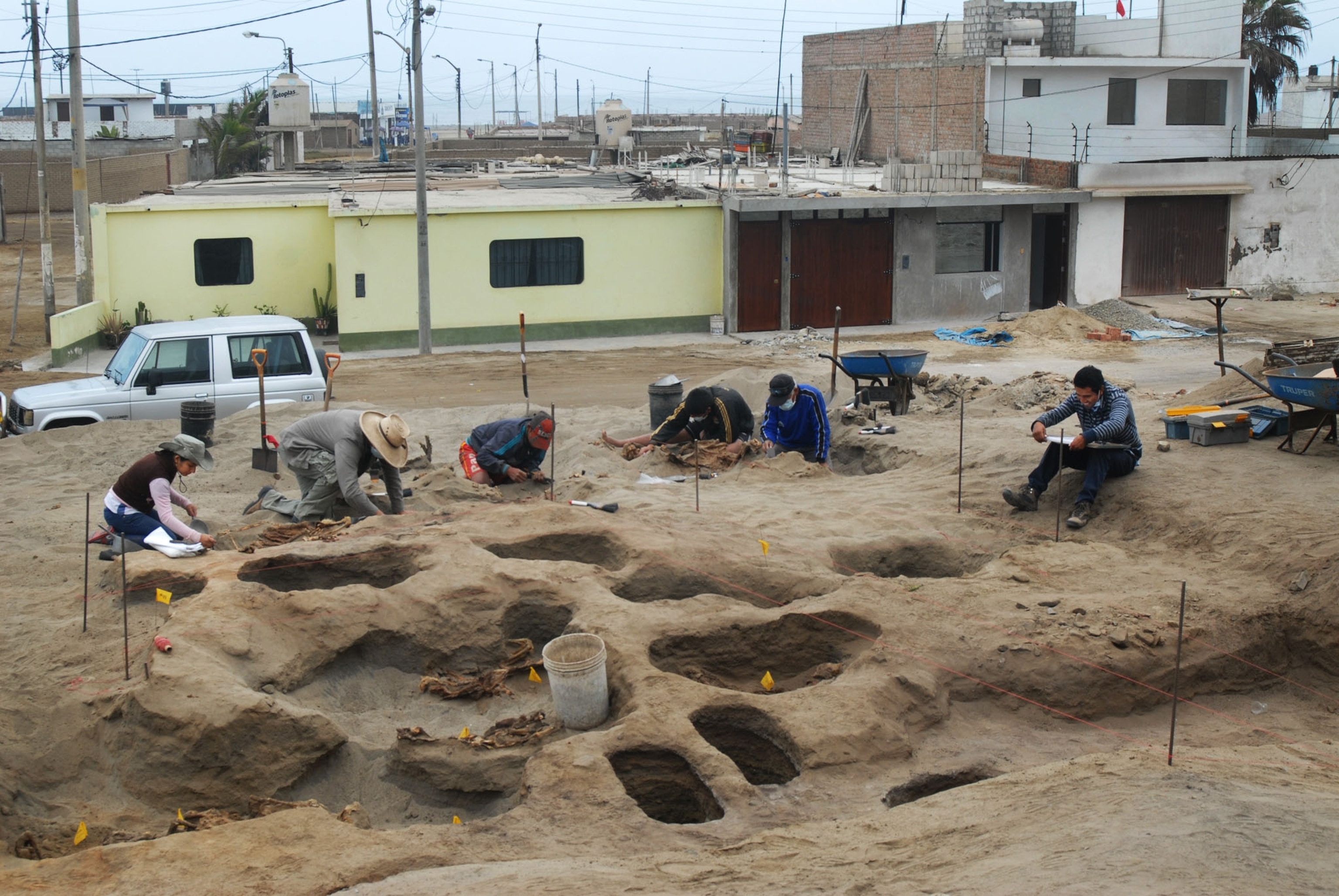 archaeology team digging at burial site.