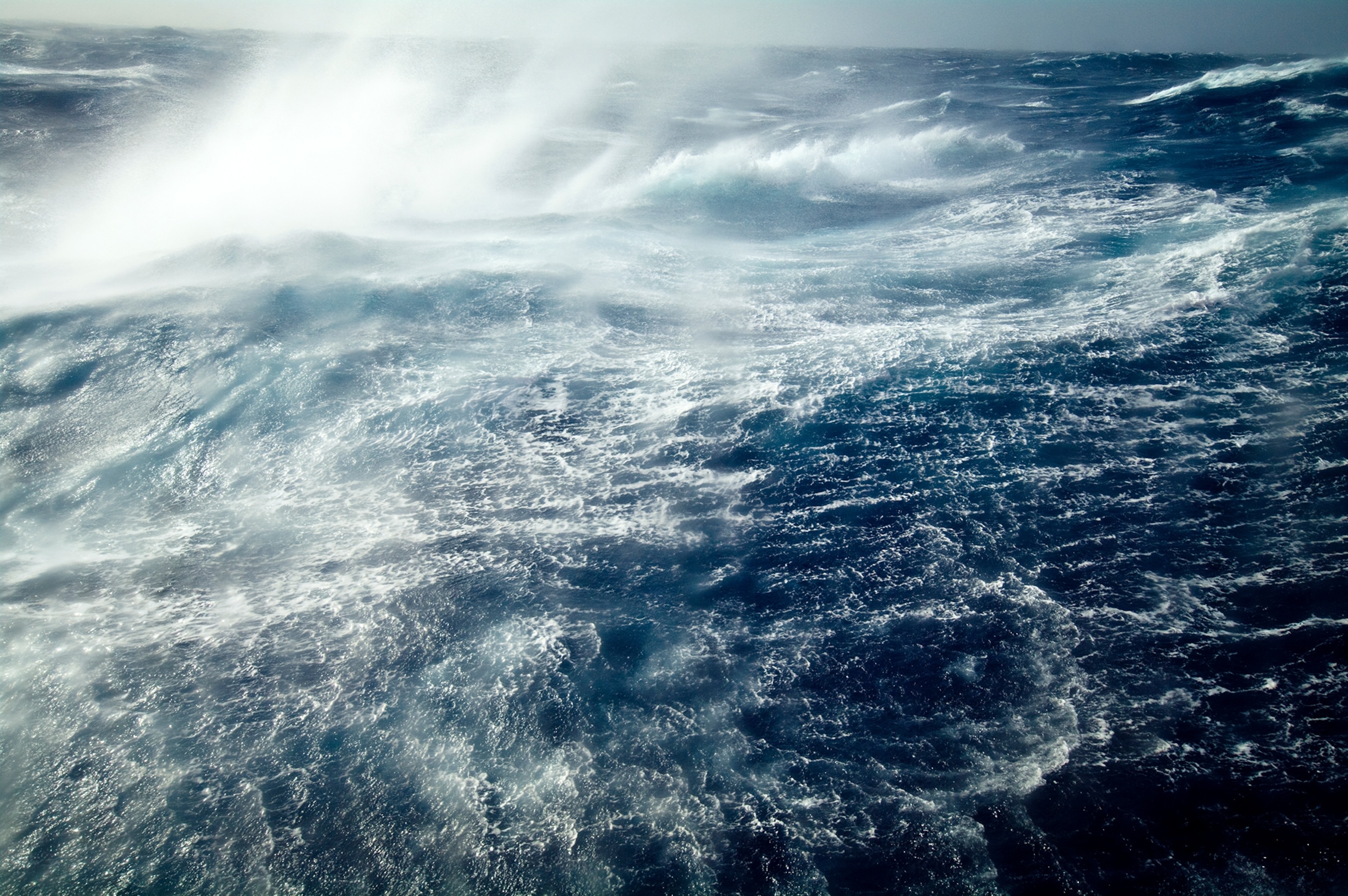 Gale force winds lash huge ocean waves into a violent stretch of water.