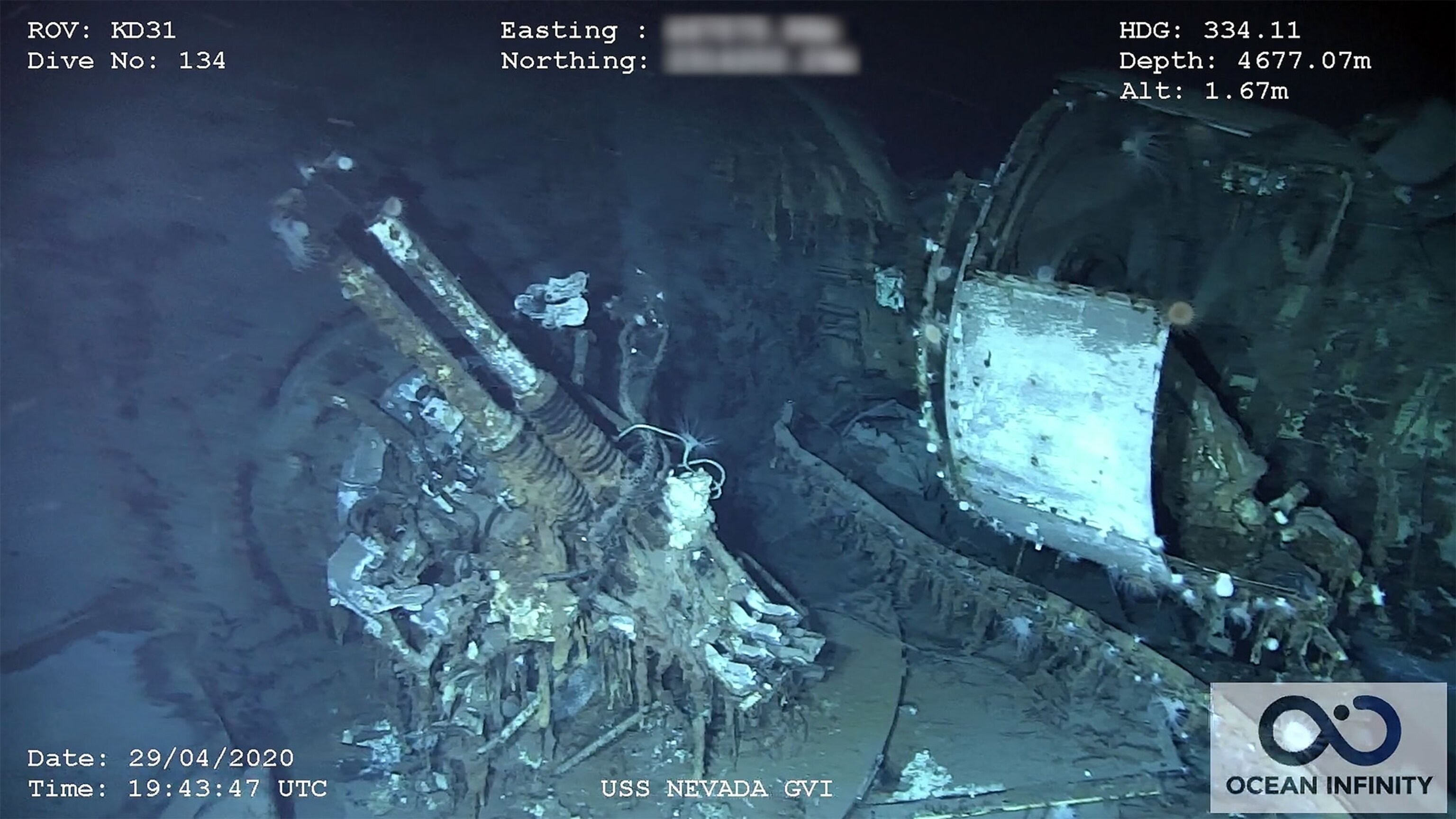 An underwater picture of a rusty large gun