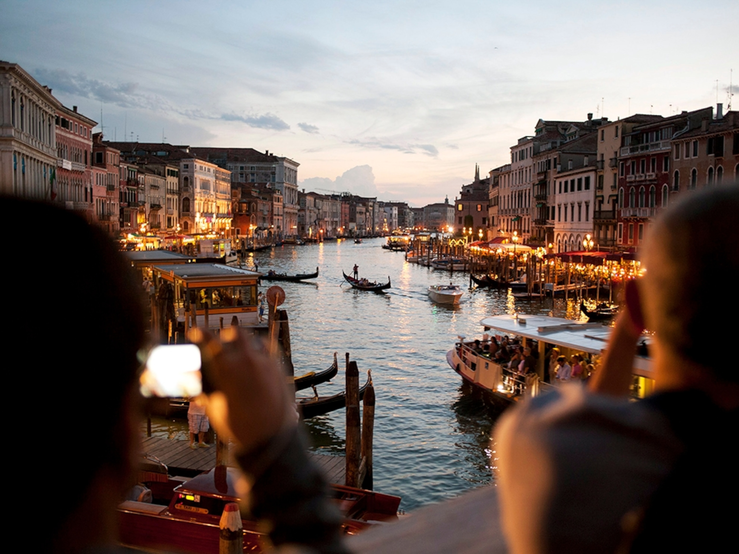 tourists on the Rialto Bridge at dusk, Venice, Italy