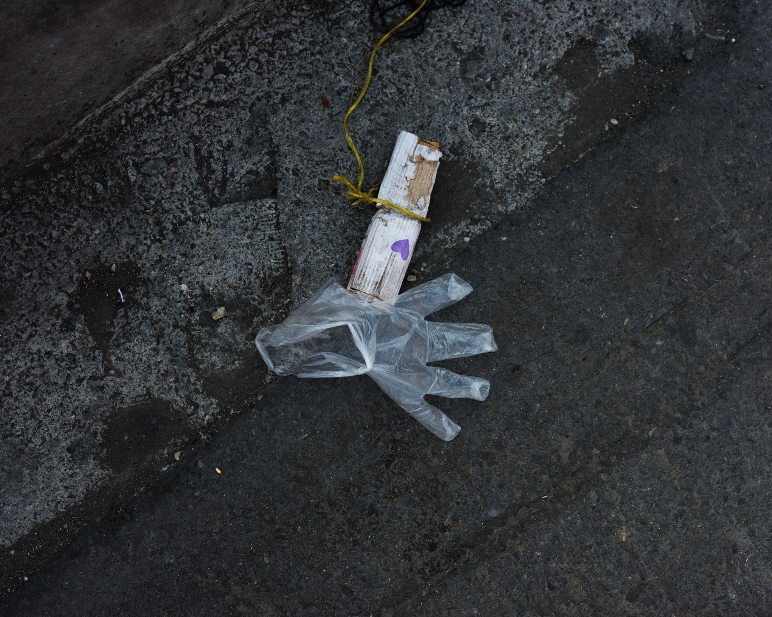 a medical glove and paper on the street
