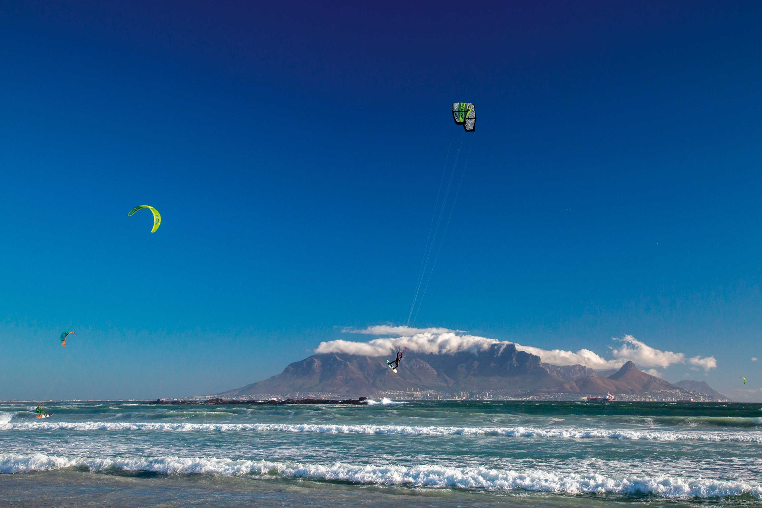 Kite surfer performing an arial stunt on the coast of Cape Town, South Africa.