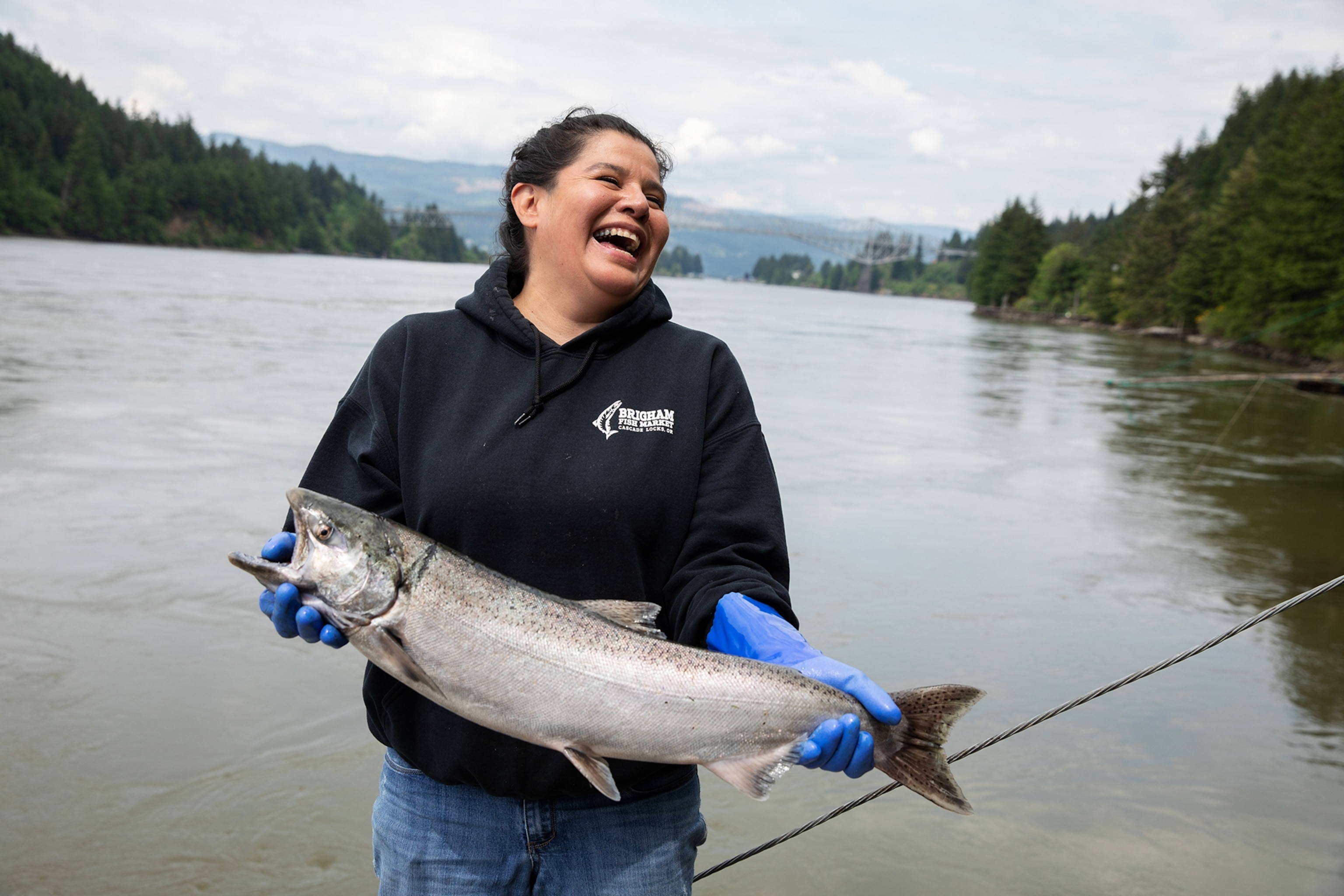 Terrie Brigham holding a spring Chinook salmon she caught, Cascade Locks, Oregon