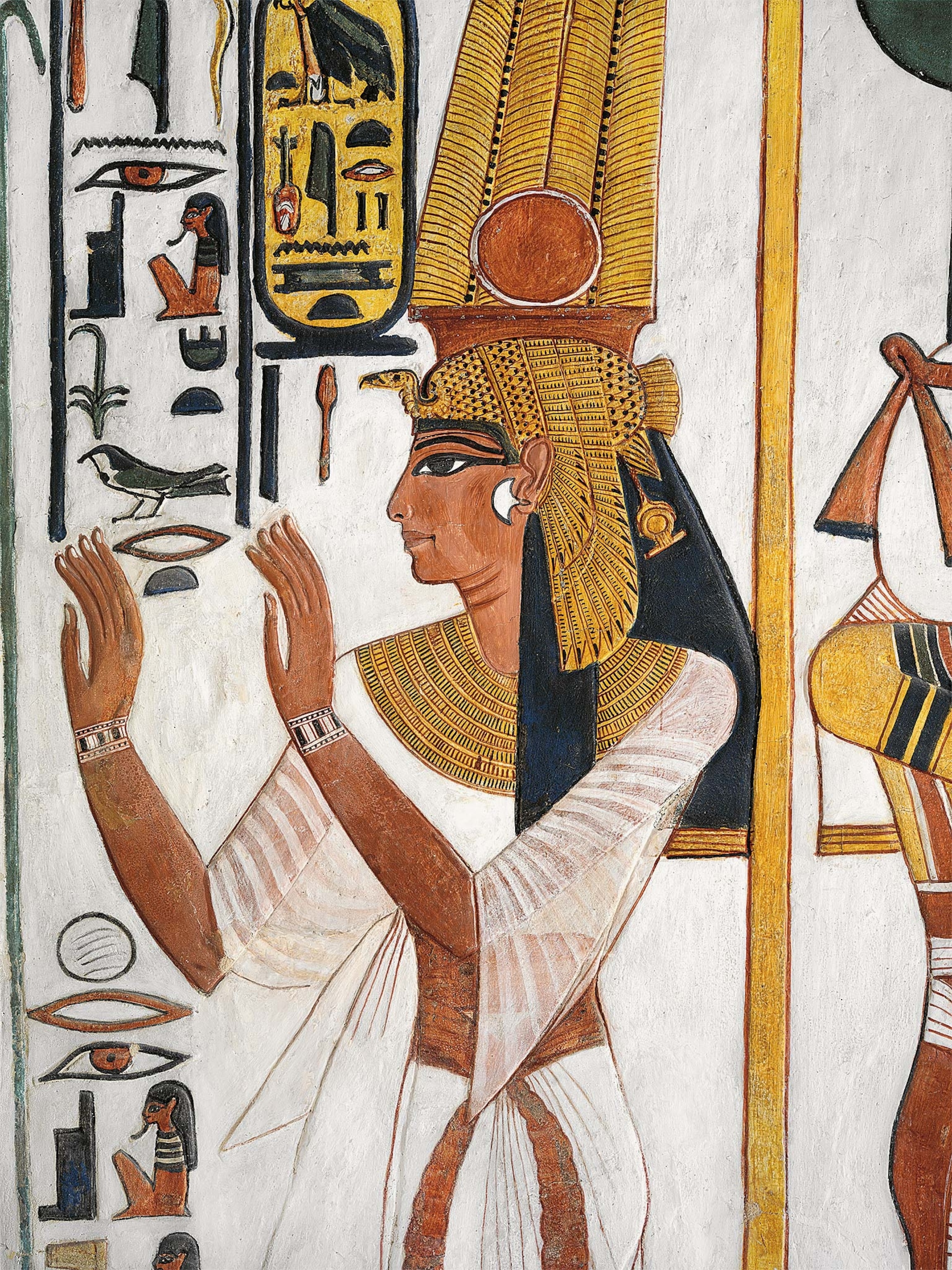 The great royal wife of Ramses II is depicted in this relief from her tomb in the Valley of the Queens. Crowned with a solar disc and feathers, her vulture headdress is associated with the protective goddess Nekhbet.