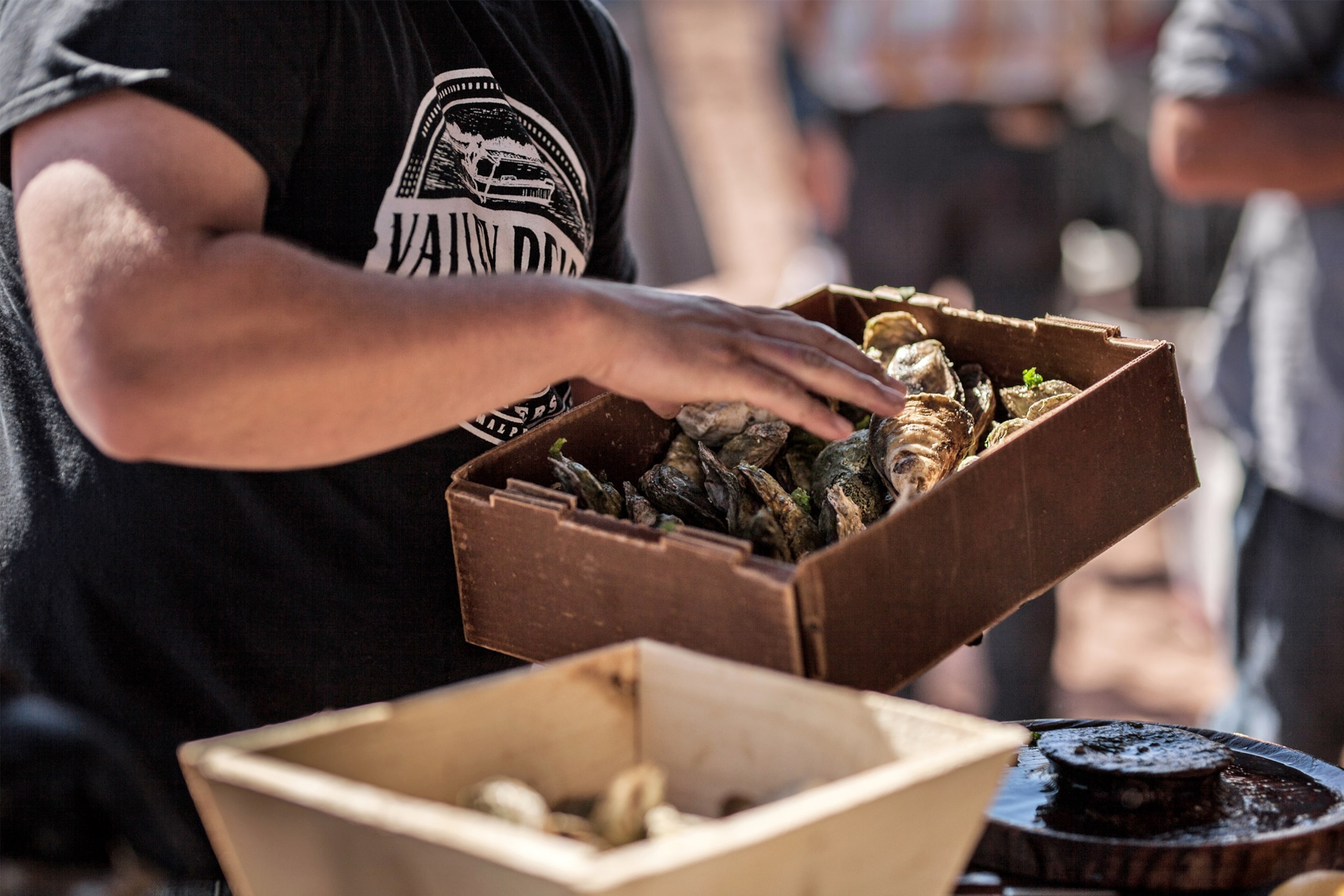 Man handles shellfish at Prince Edward Island food festival