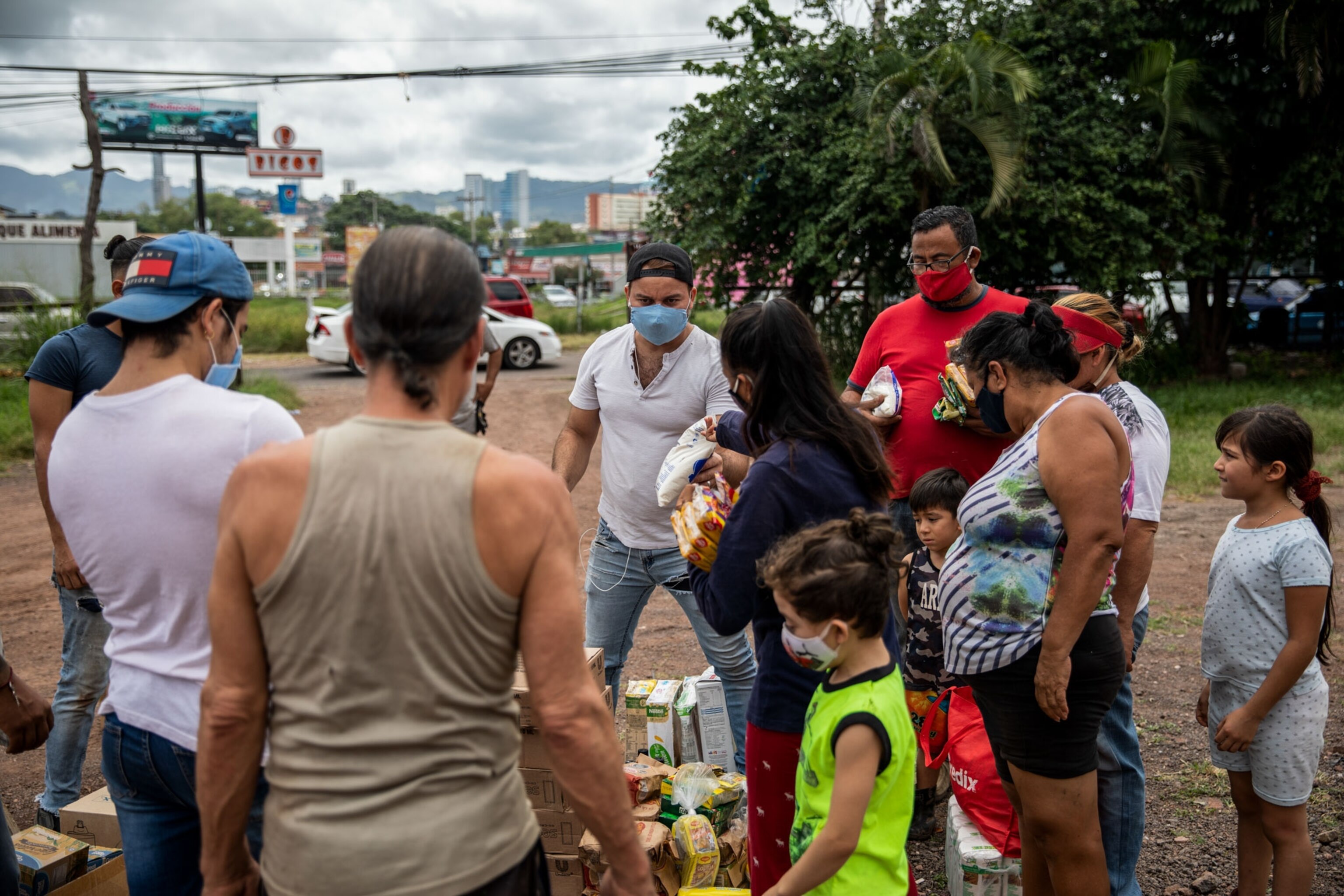 a man handing out food donations in Honduras