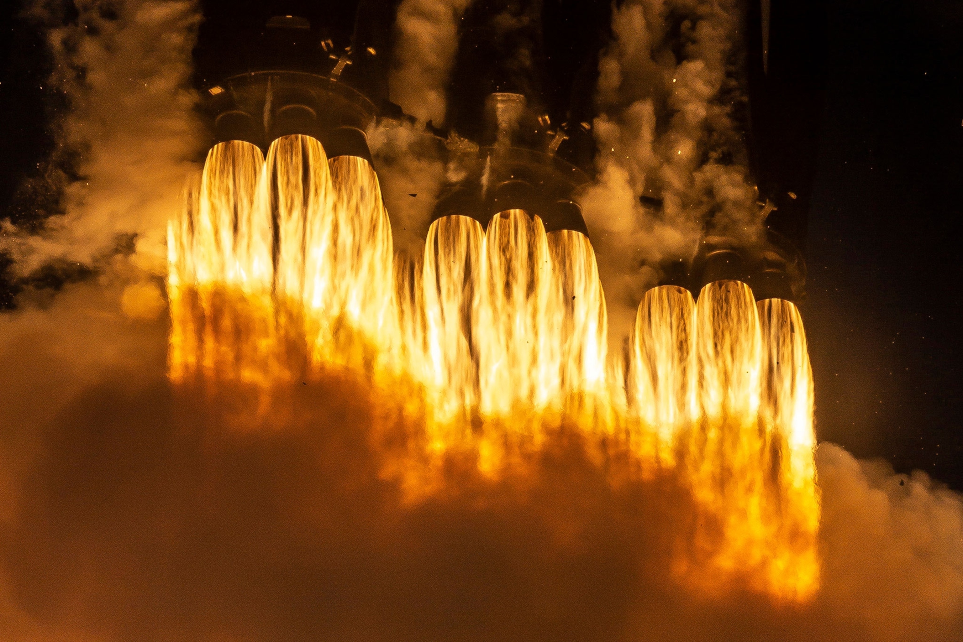 Rockets fire on SPACEX's Falcon Heavy.