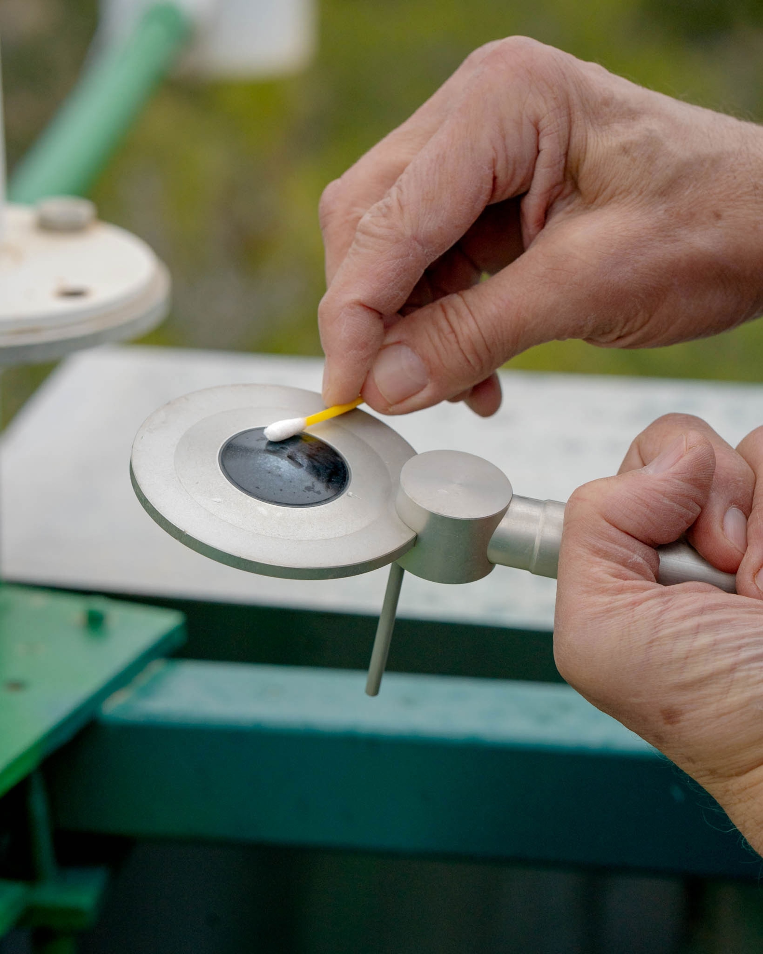 a sensor is cleaned using a q-tip