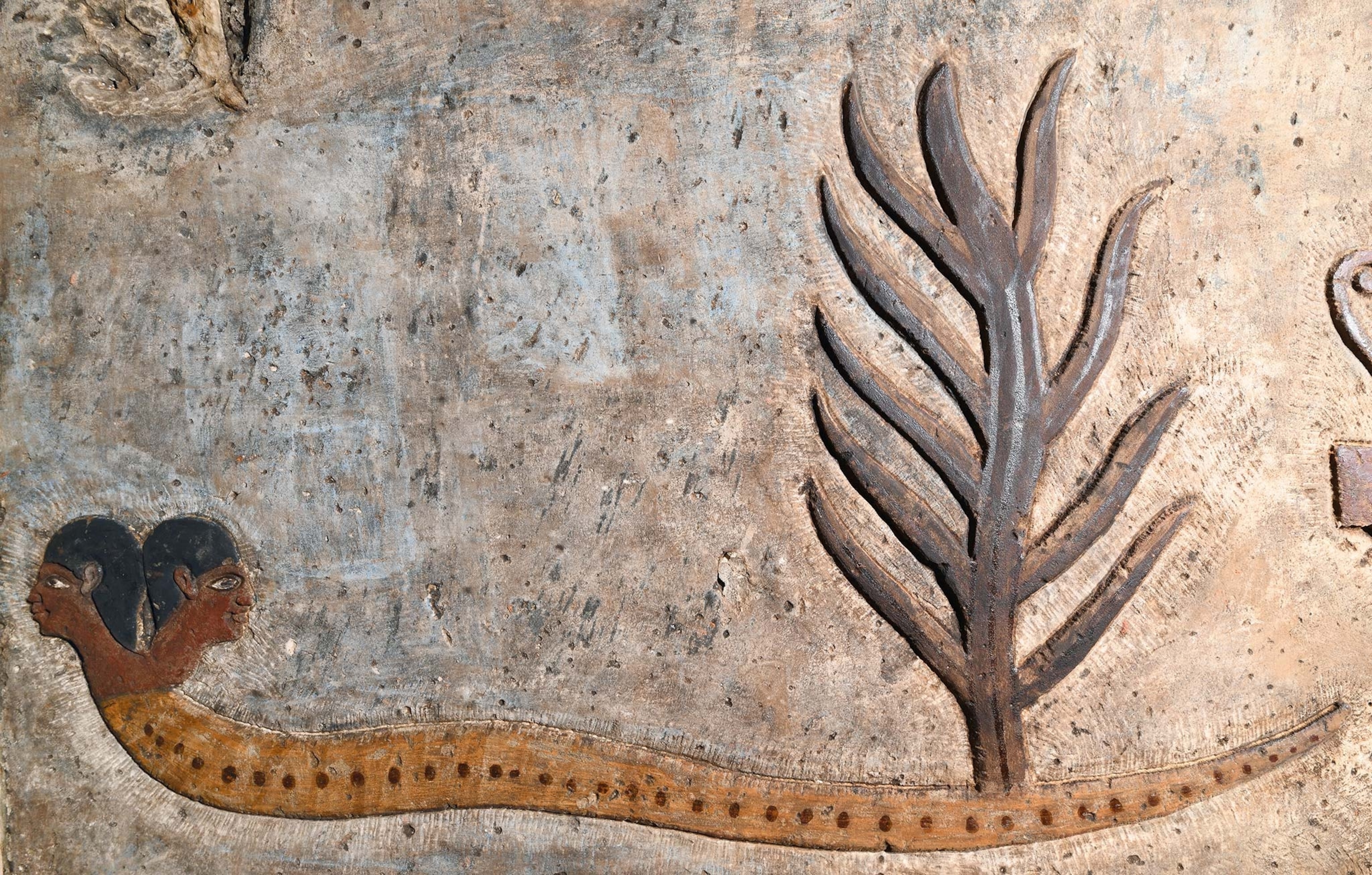 A two-headed serpent with a tree growing from its tail