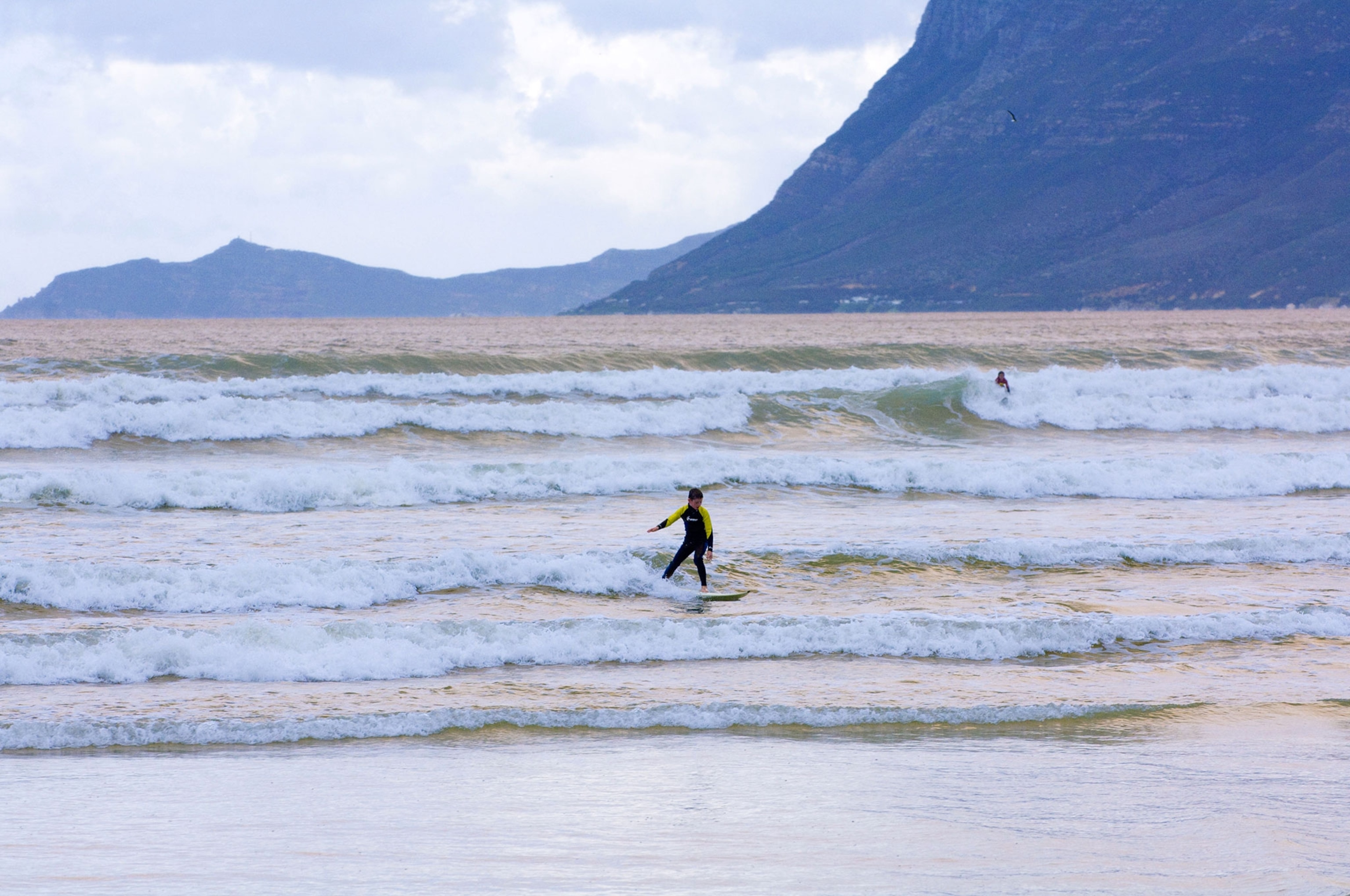 a surfer on Muizenberg Beach, South Africa