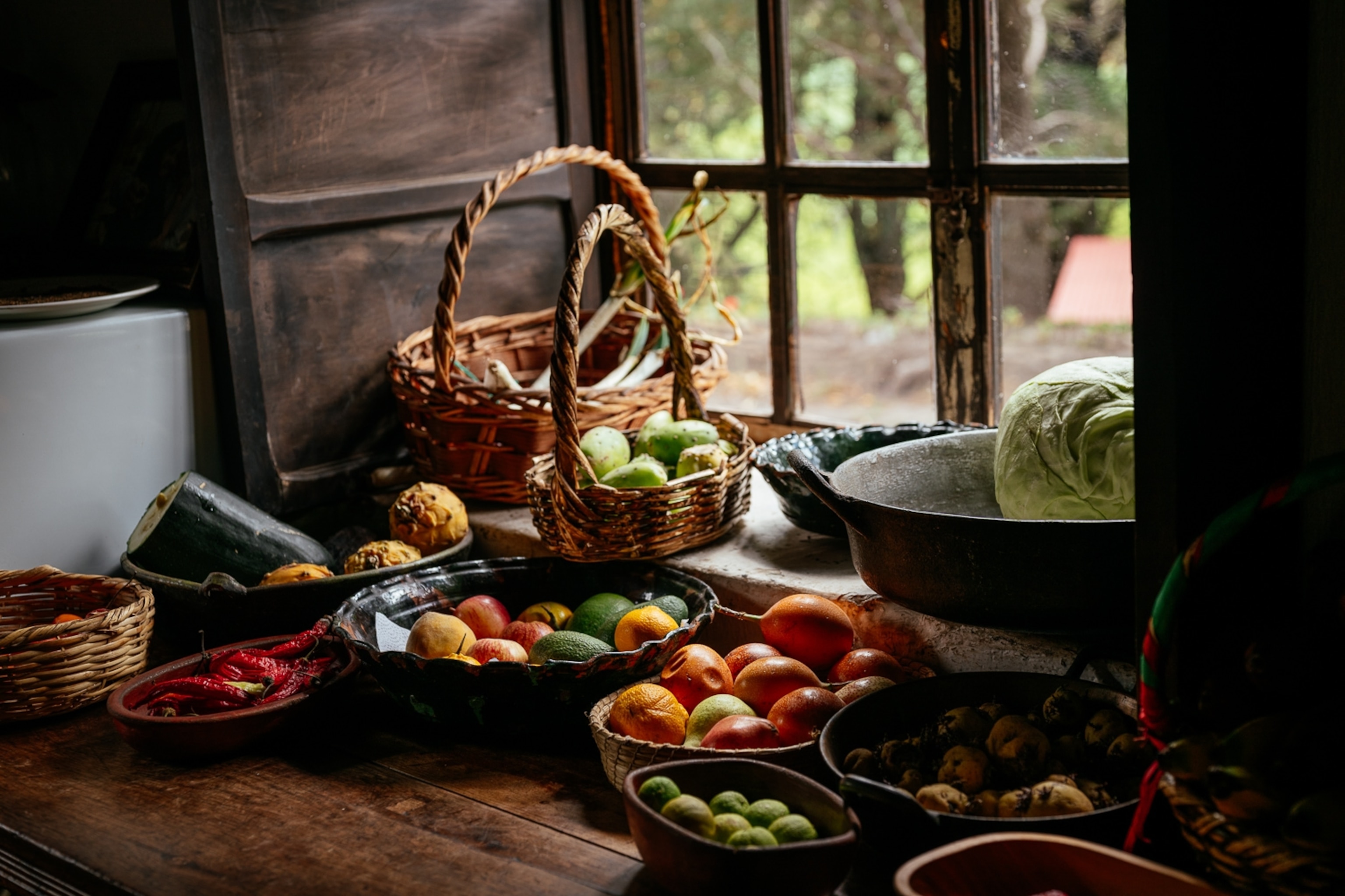 Fruits and vegetables placed by a window at the Posada de Tigua hotel in Cotapaxi Province, Ecuador.