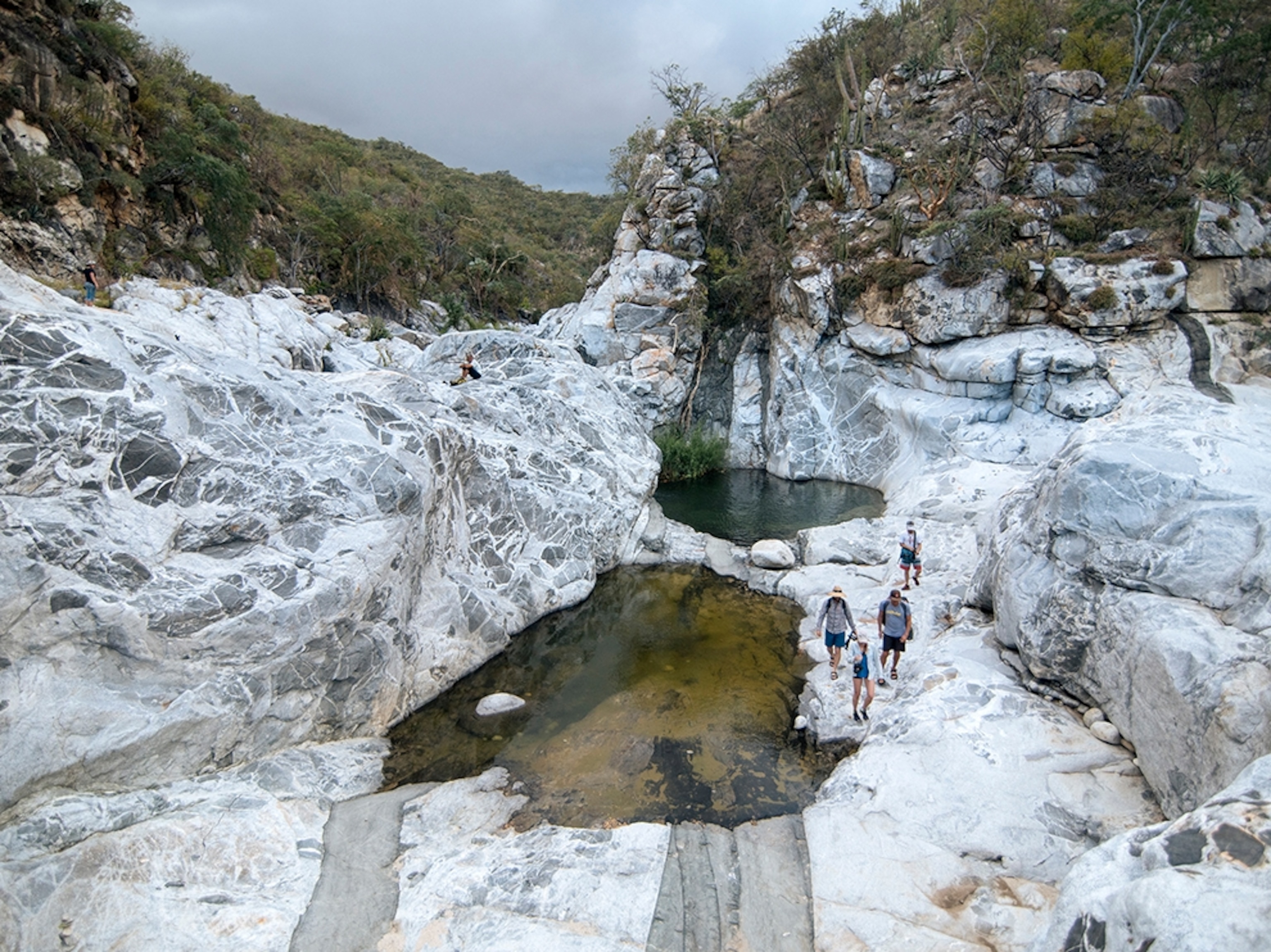 hikers exploring a canyon near Aguas Calientes, Baja, Mexico