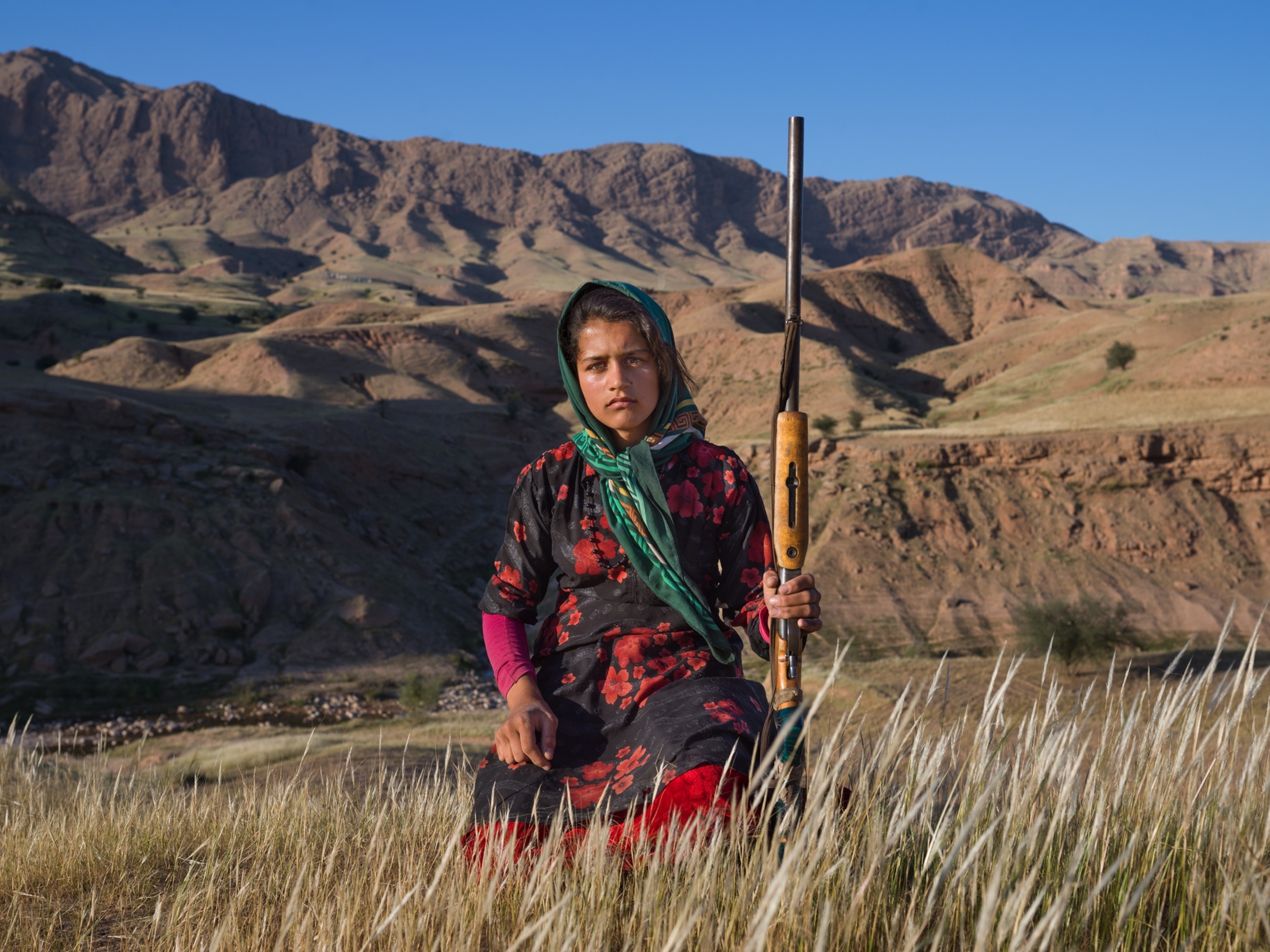 young woman holding a shotgun.