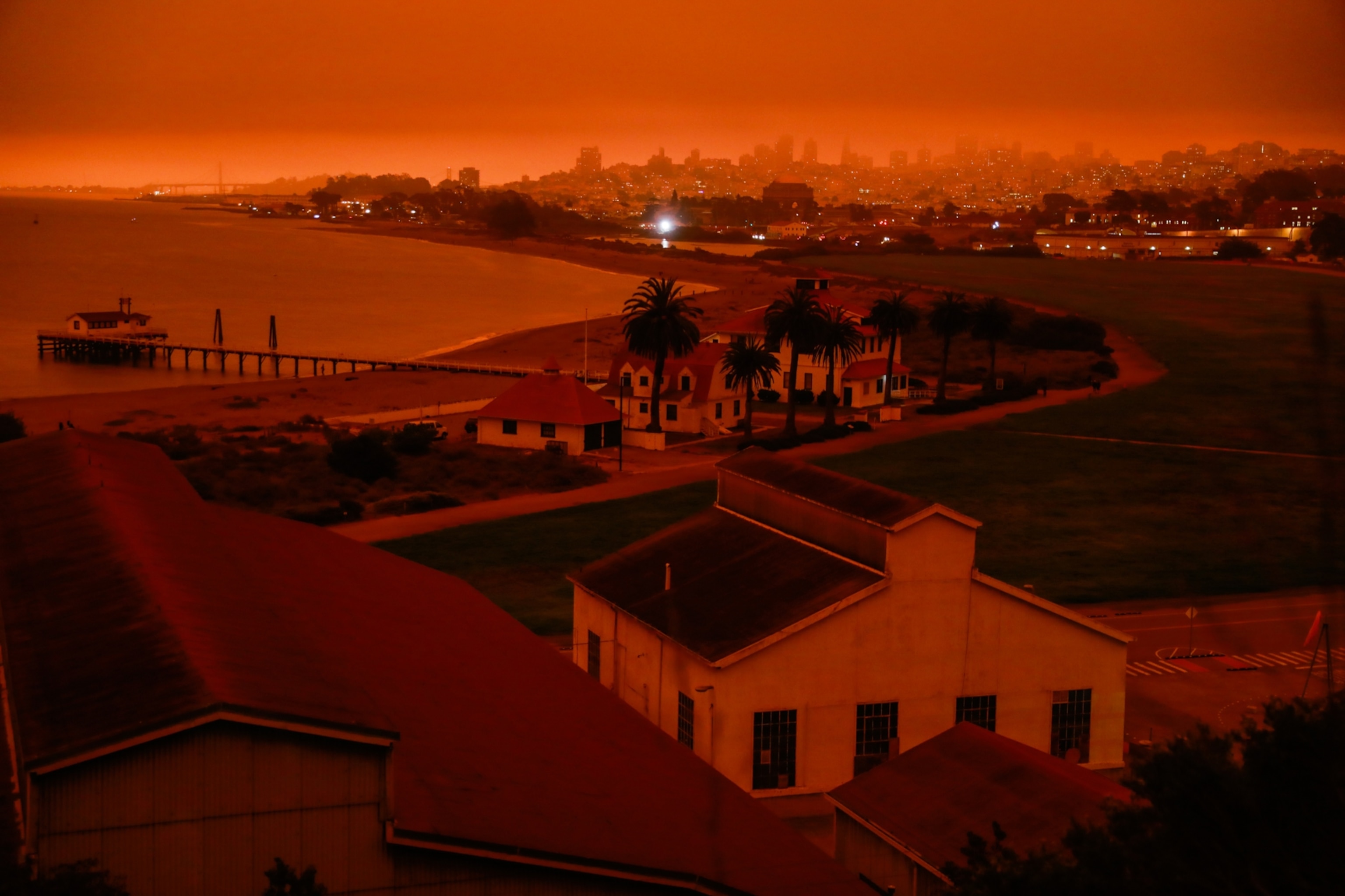 presidio and the bay shrouded in dark orange smoke
