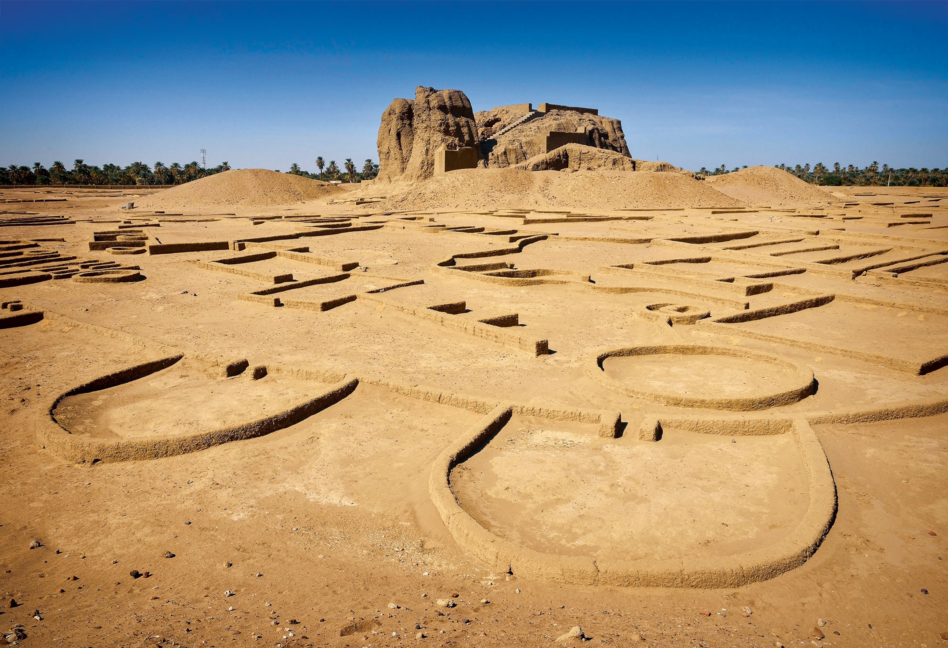Ruins of an ancient capital leaves behind short mud-brick walls circling in the desert