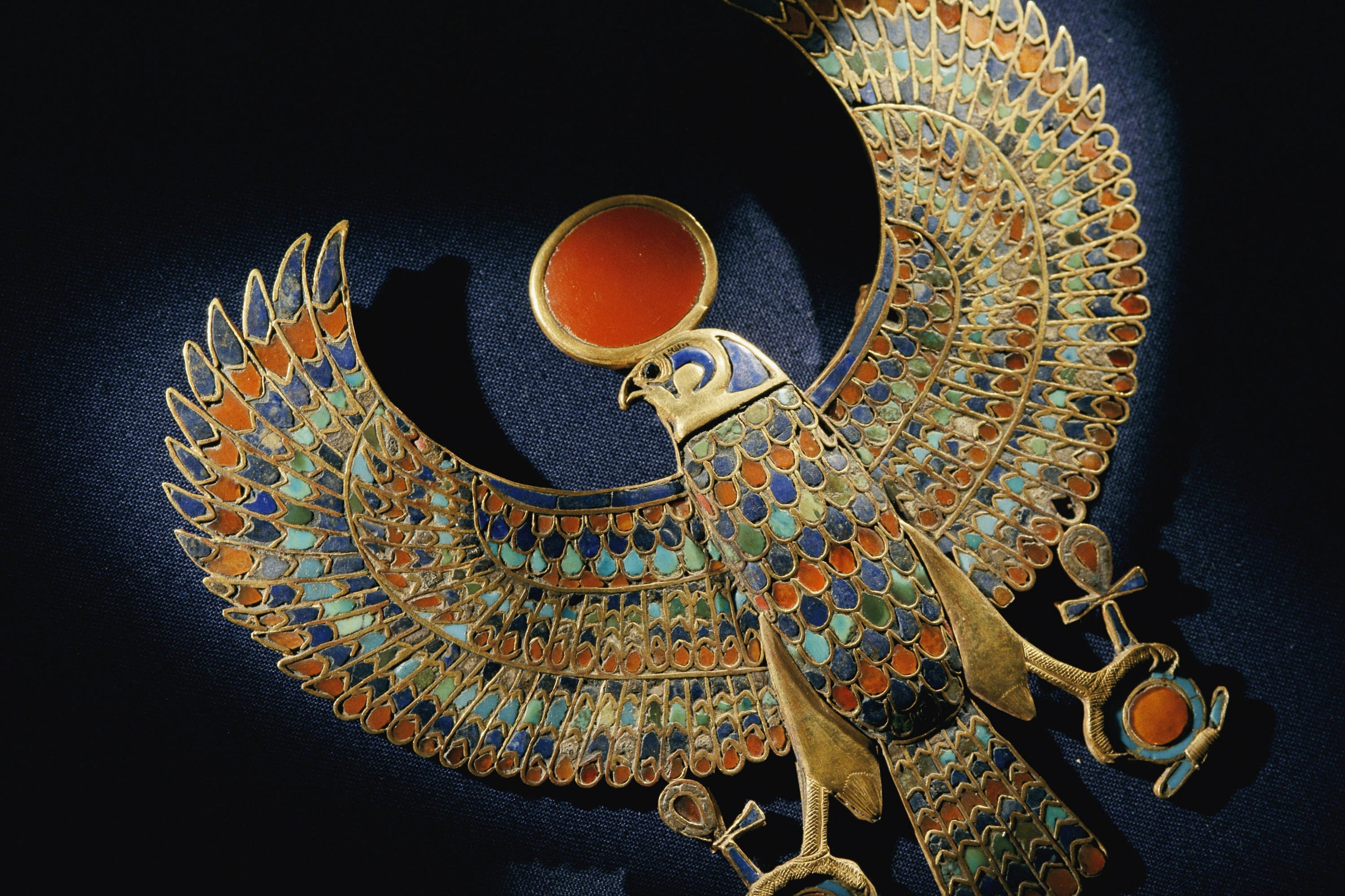 a gold pendant of hawk