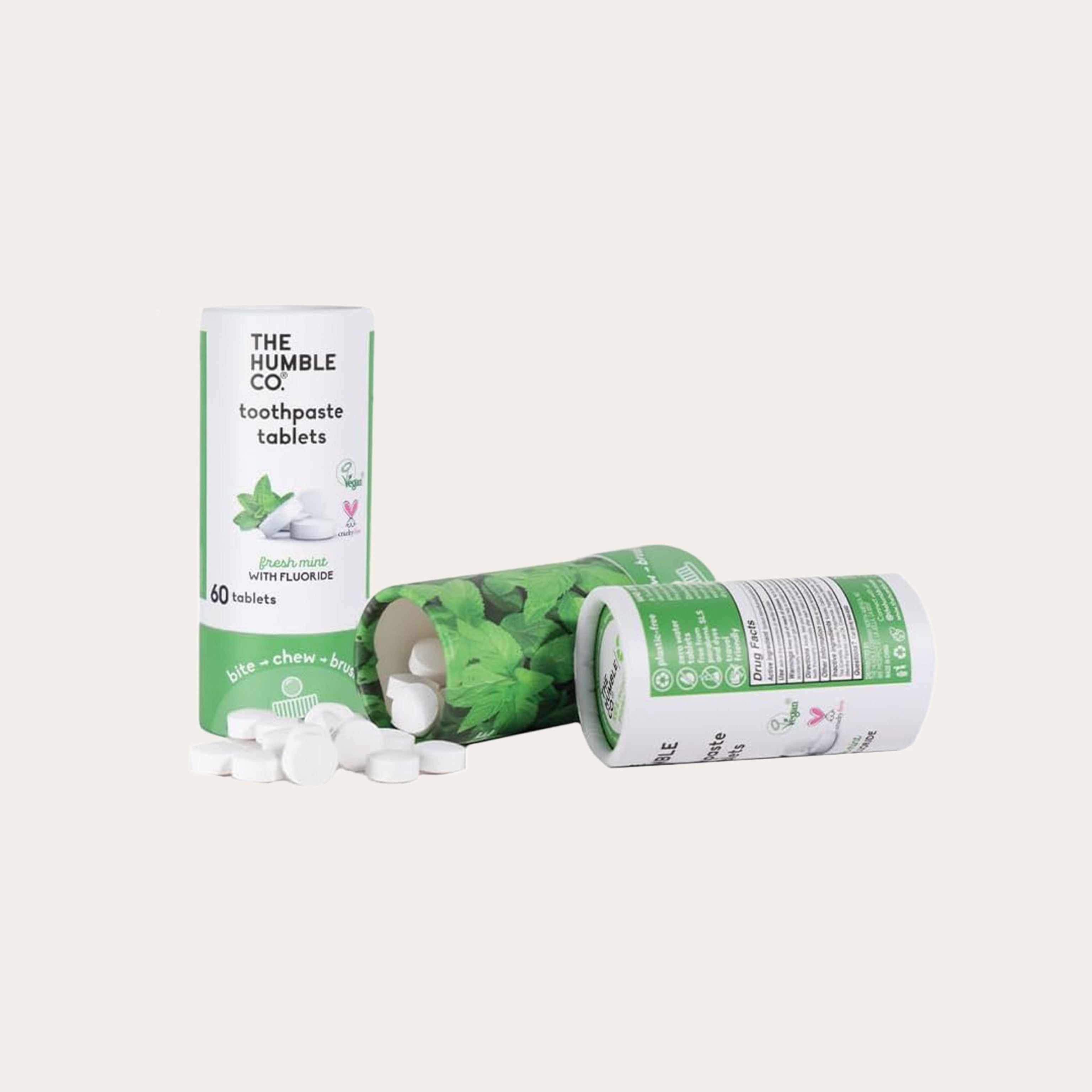 Three green and white cardboard gum containers.