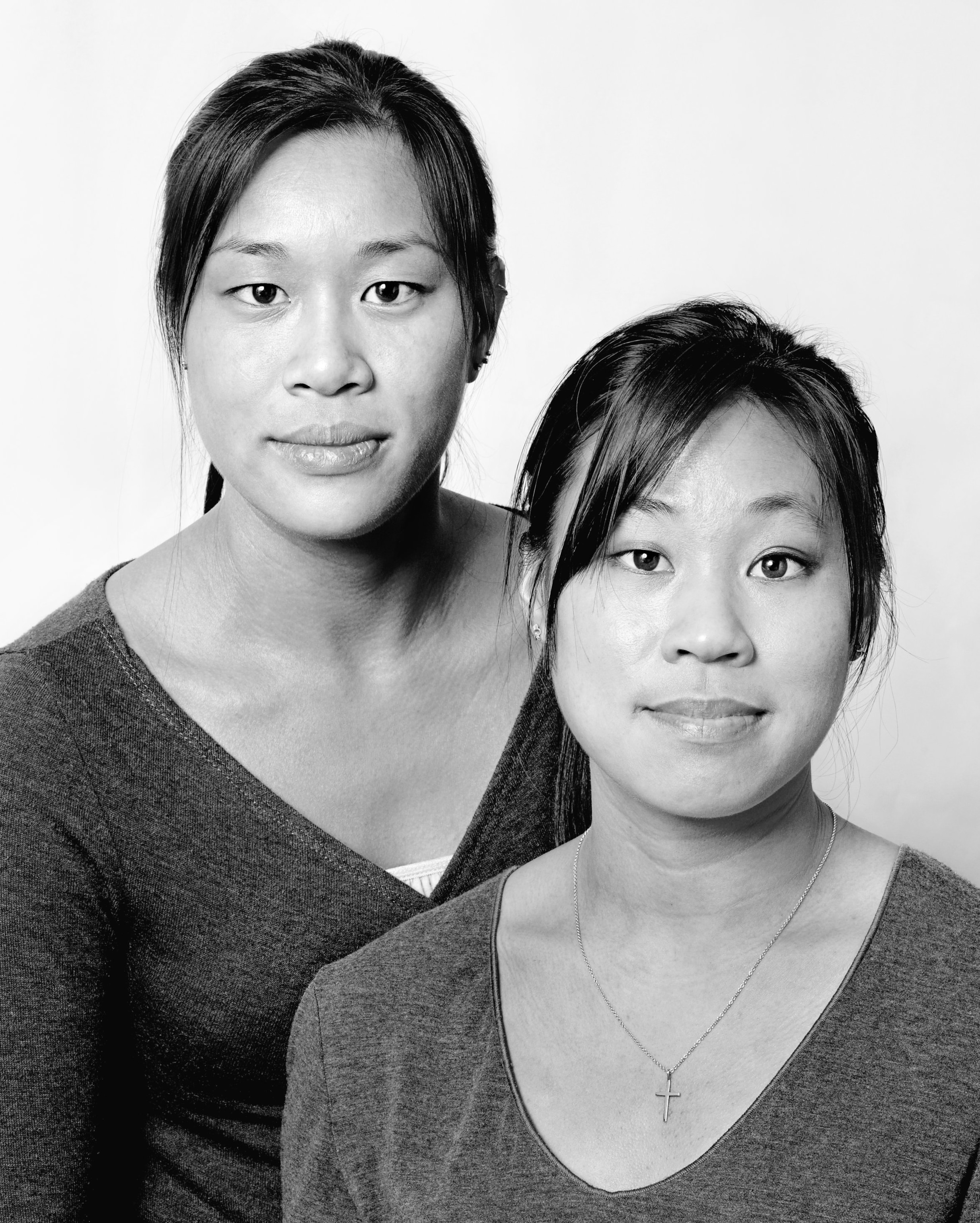Head-and-shoulders portrait of two young Asian women who resemble each other closely