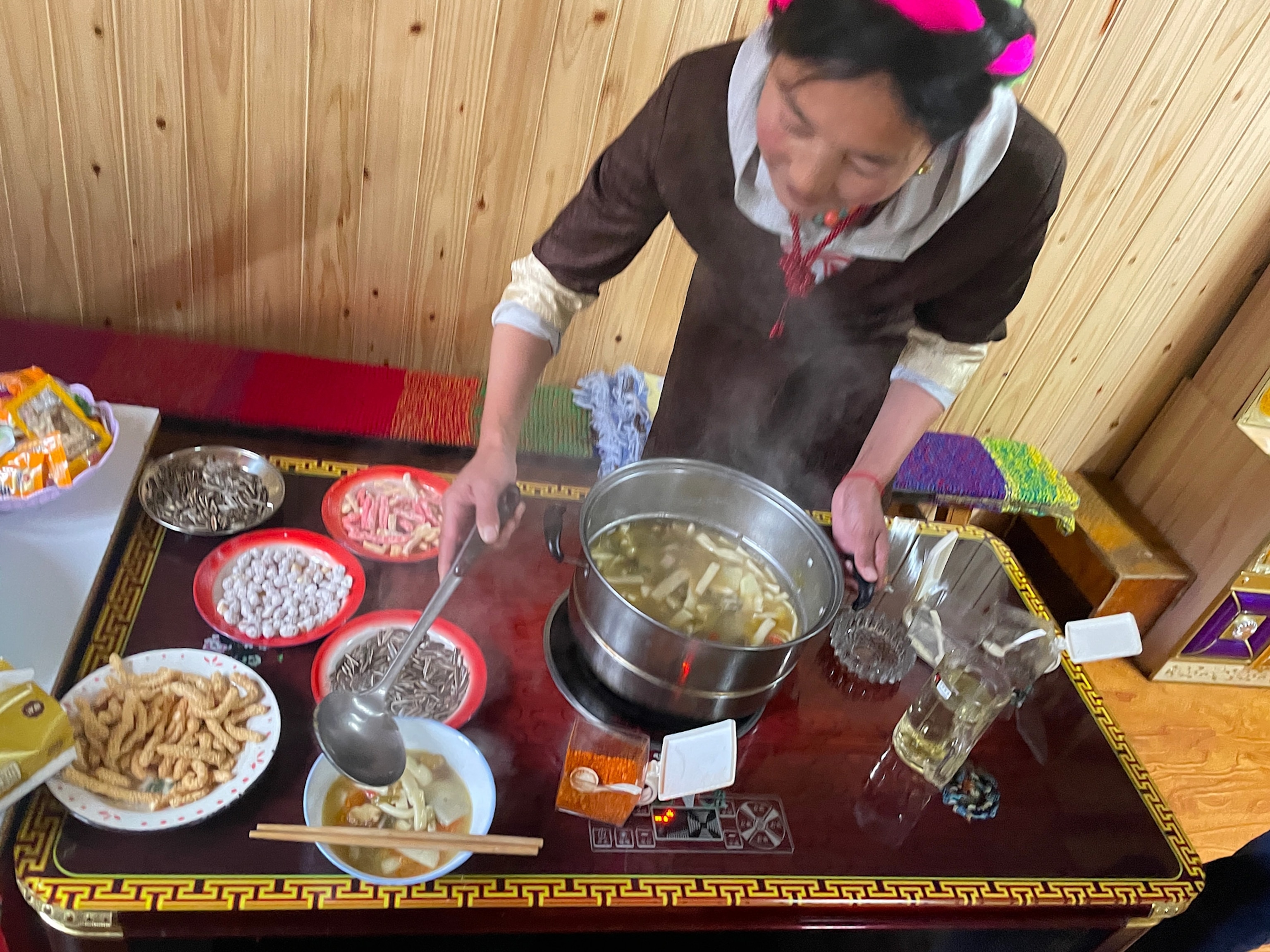 photo of woman ladling soup