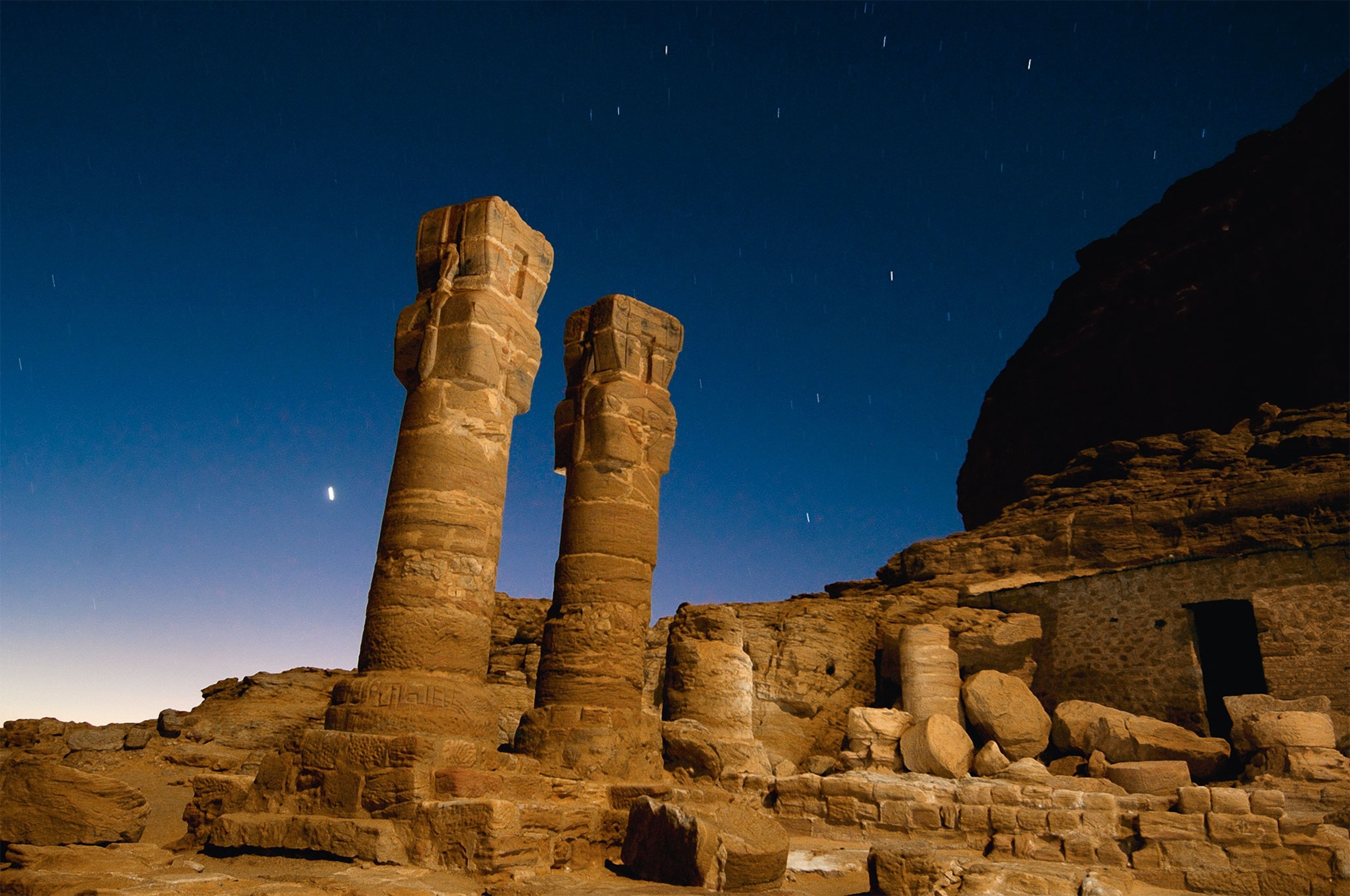 Ruins of a temple with columns still standing in a desert