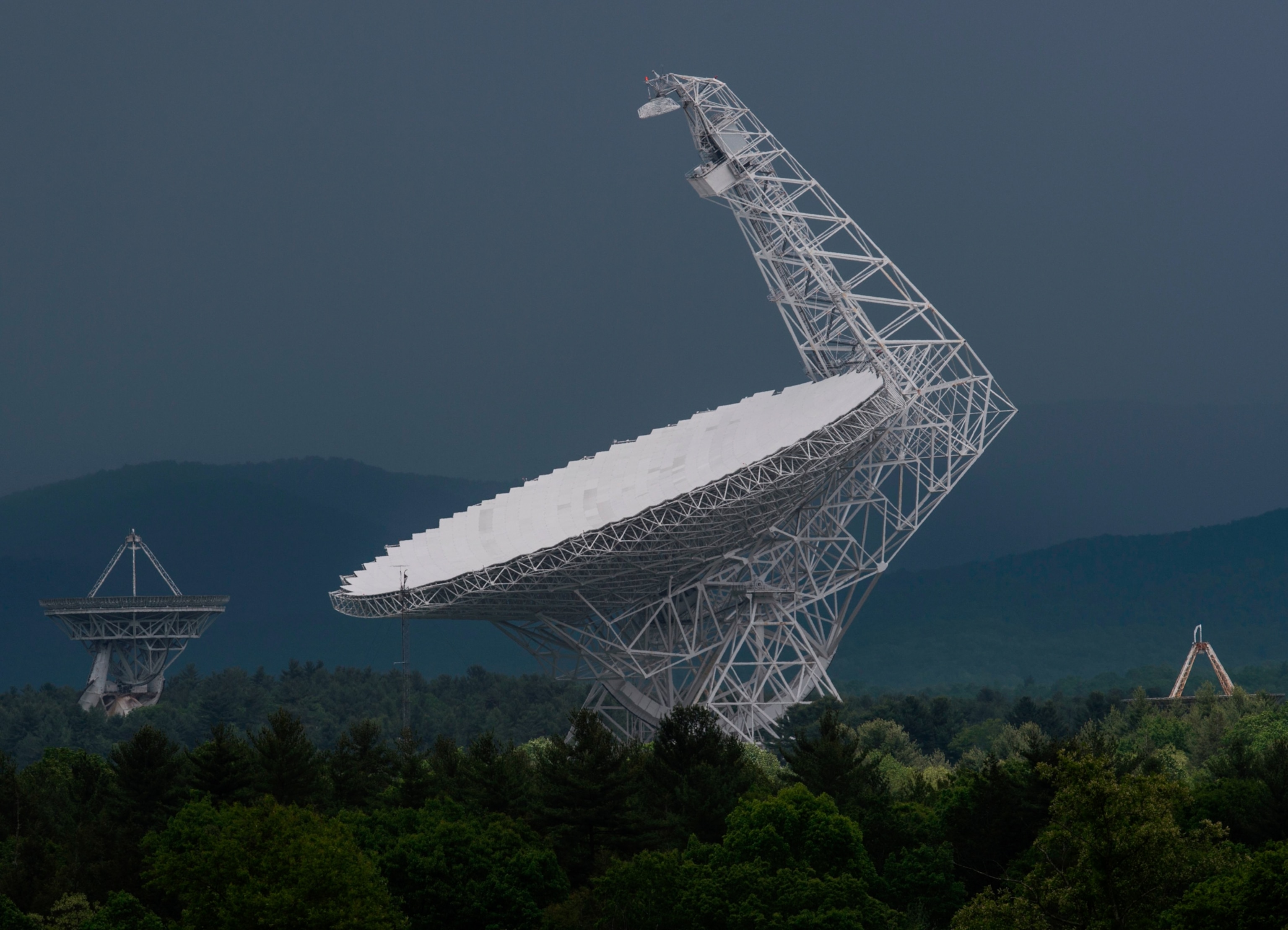 The Green Bank Telescope is seen standing tall above the trees in Green Bank, West Virginia.
