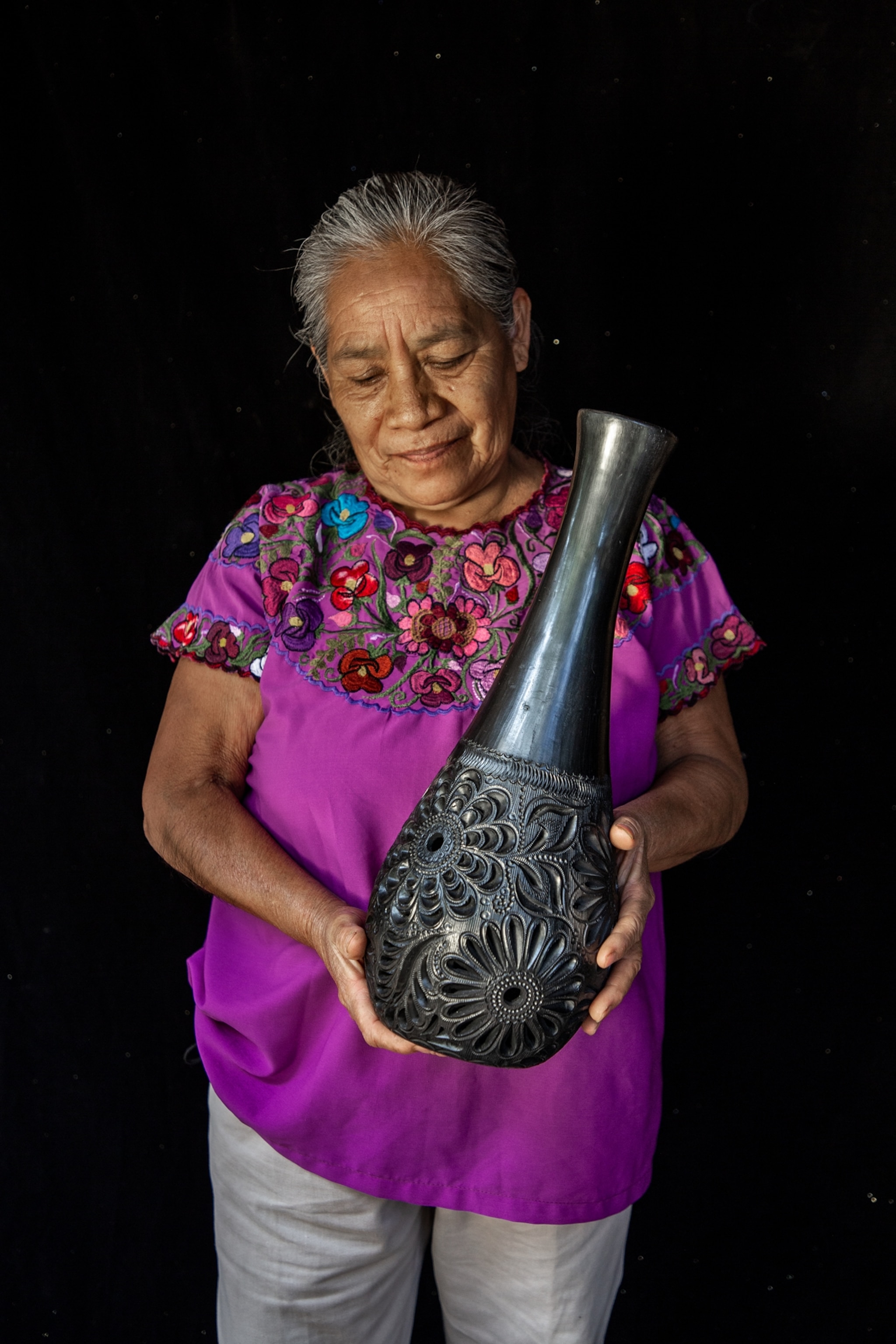 Silvia Garcia holding her piece of black pottery