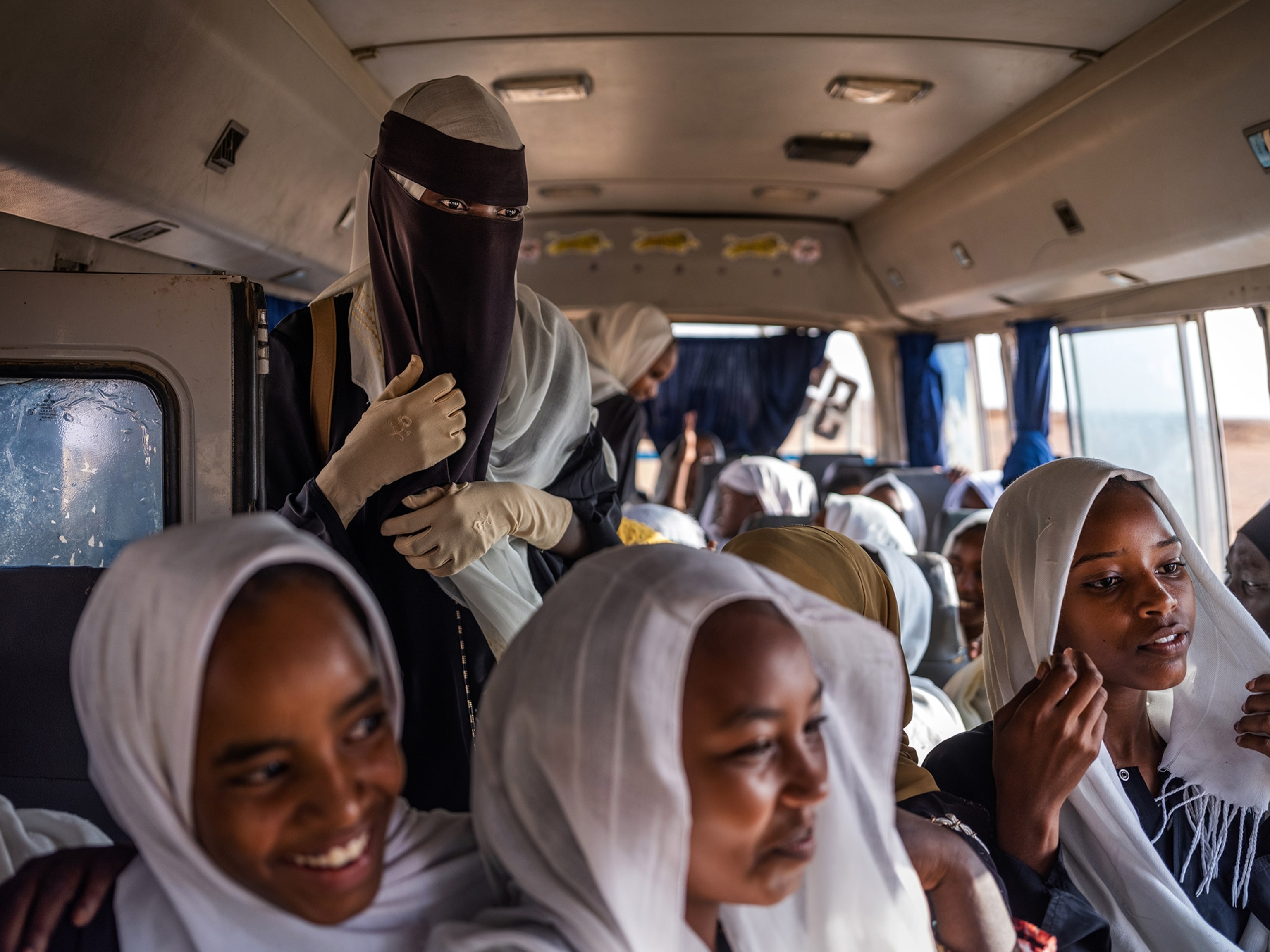 “For Education” local youth volunteers lead a group of schoolchildren on a tour of the Meroë pyramids, Sudan, during their school break