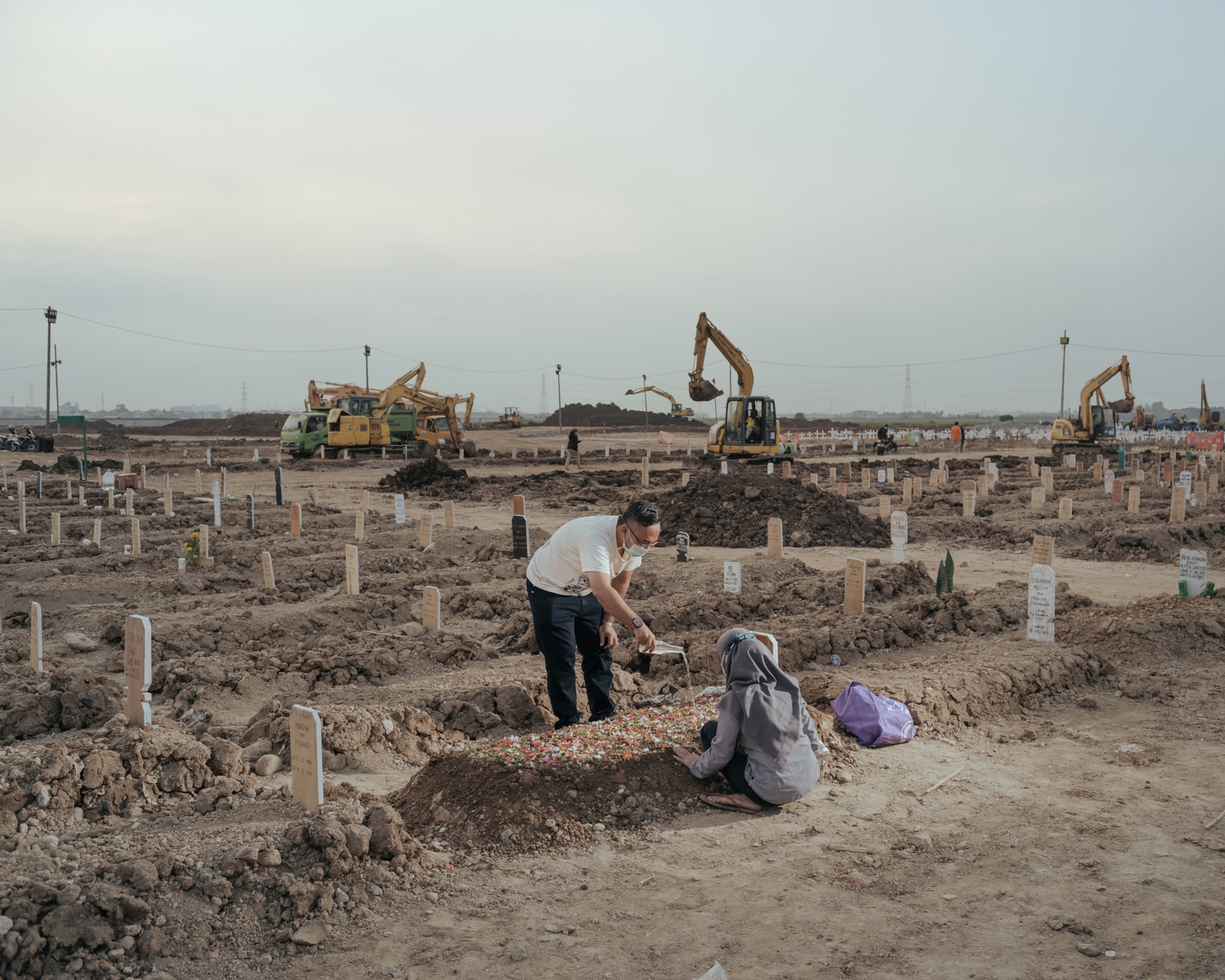 family members visit a family members grave in Indonesia