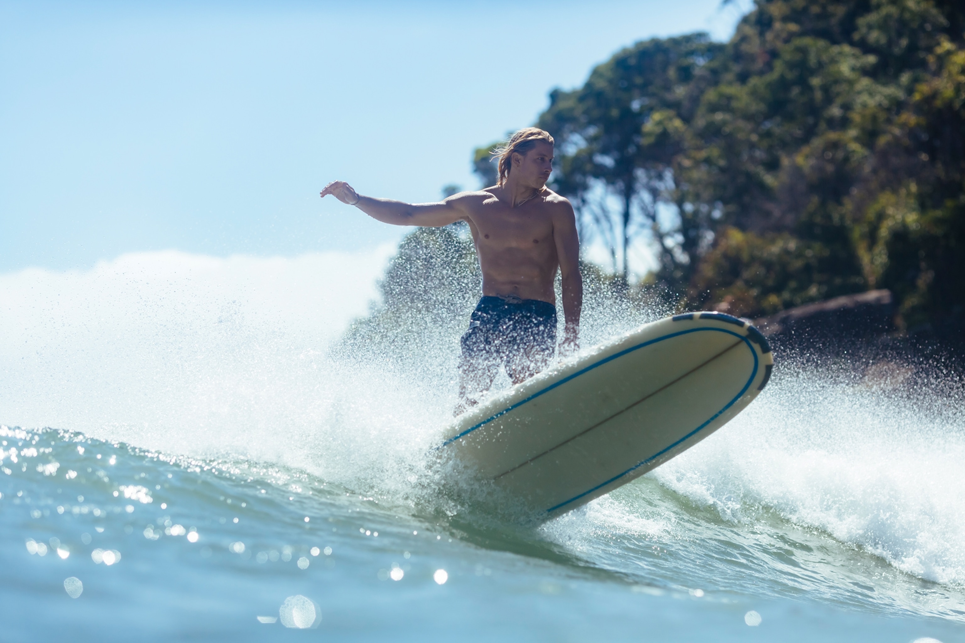 A person surfing in Noosa National Park, Australia.