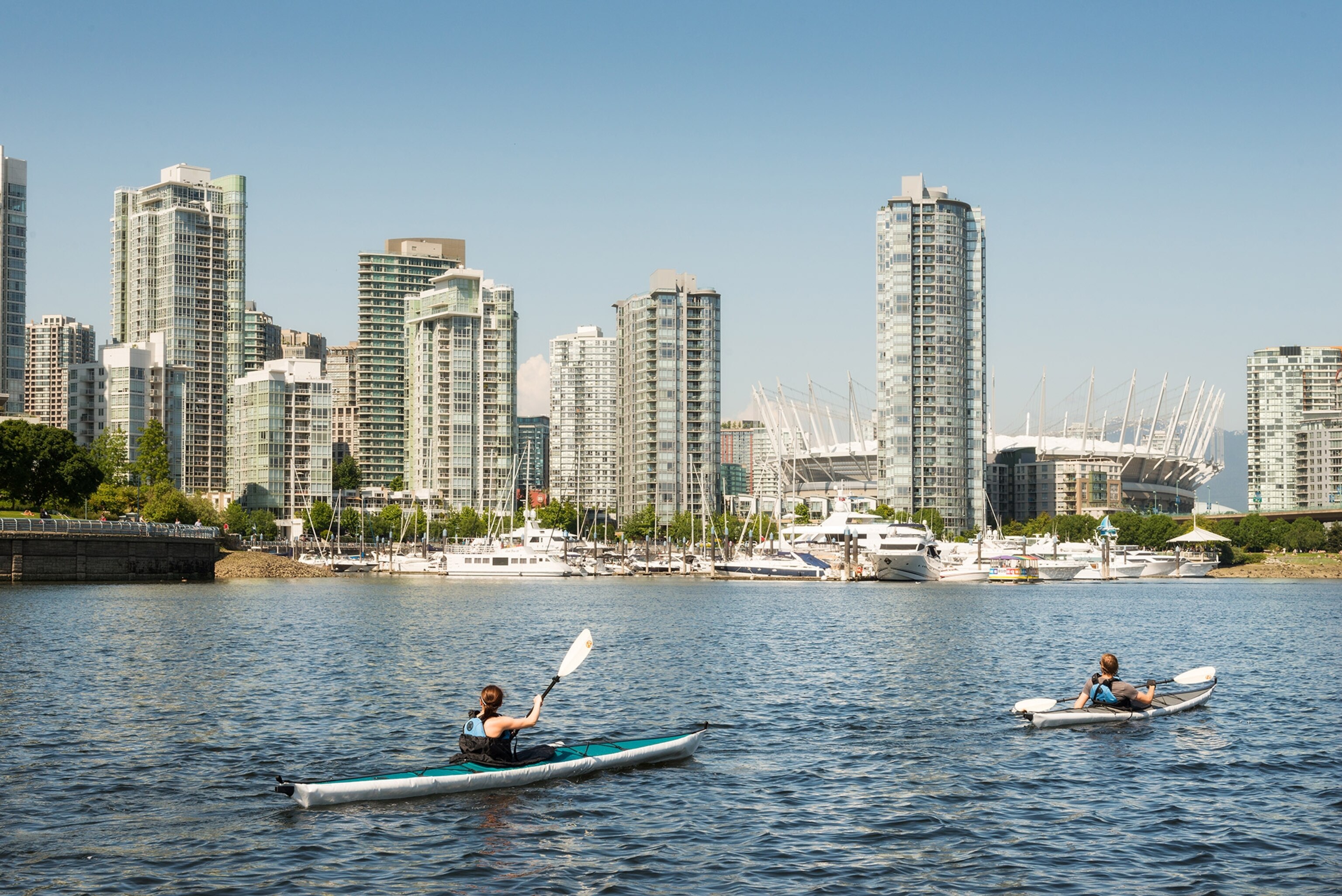 kayakers with the Vancouver, Canada skyline in the background