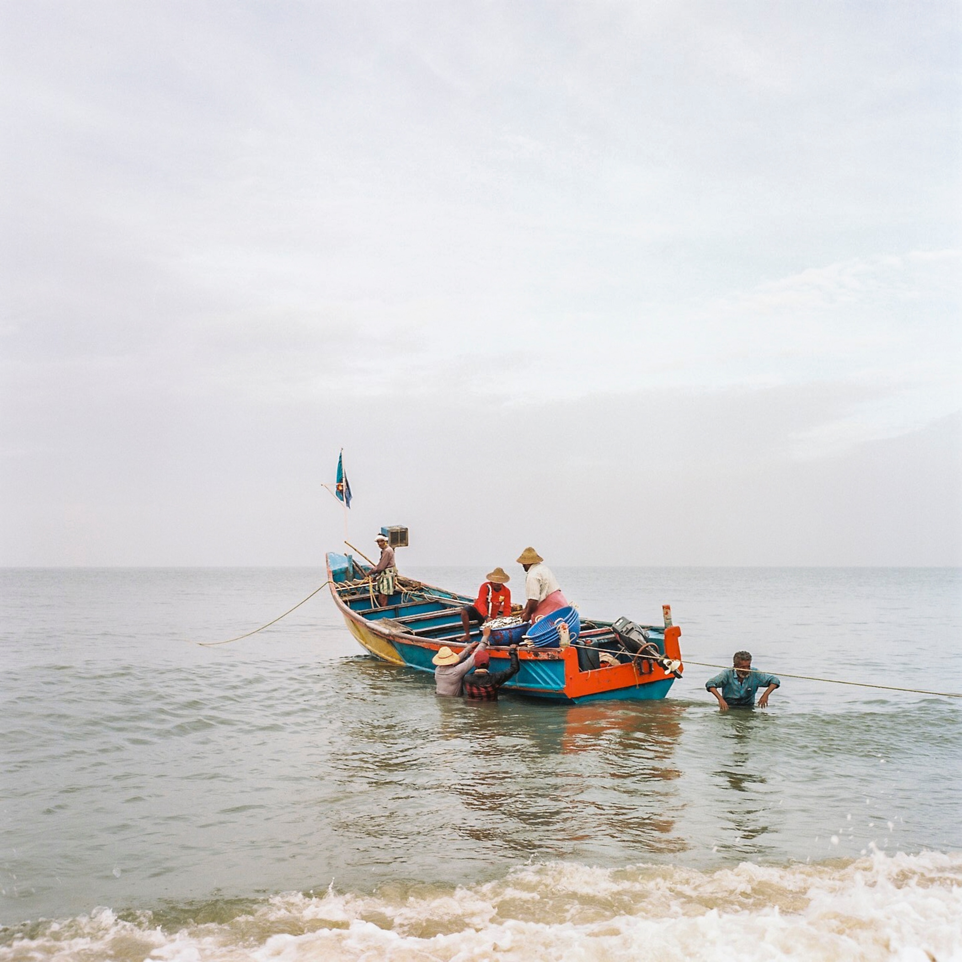 Fishermen arrive back to the shore at the Alleppey fish harbour