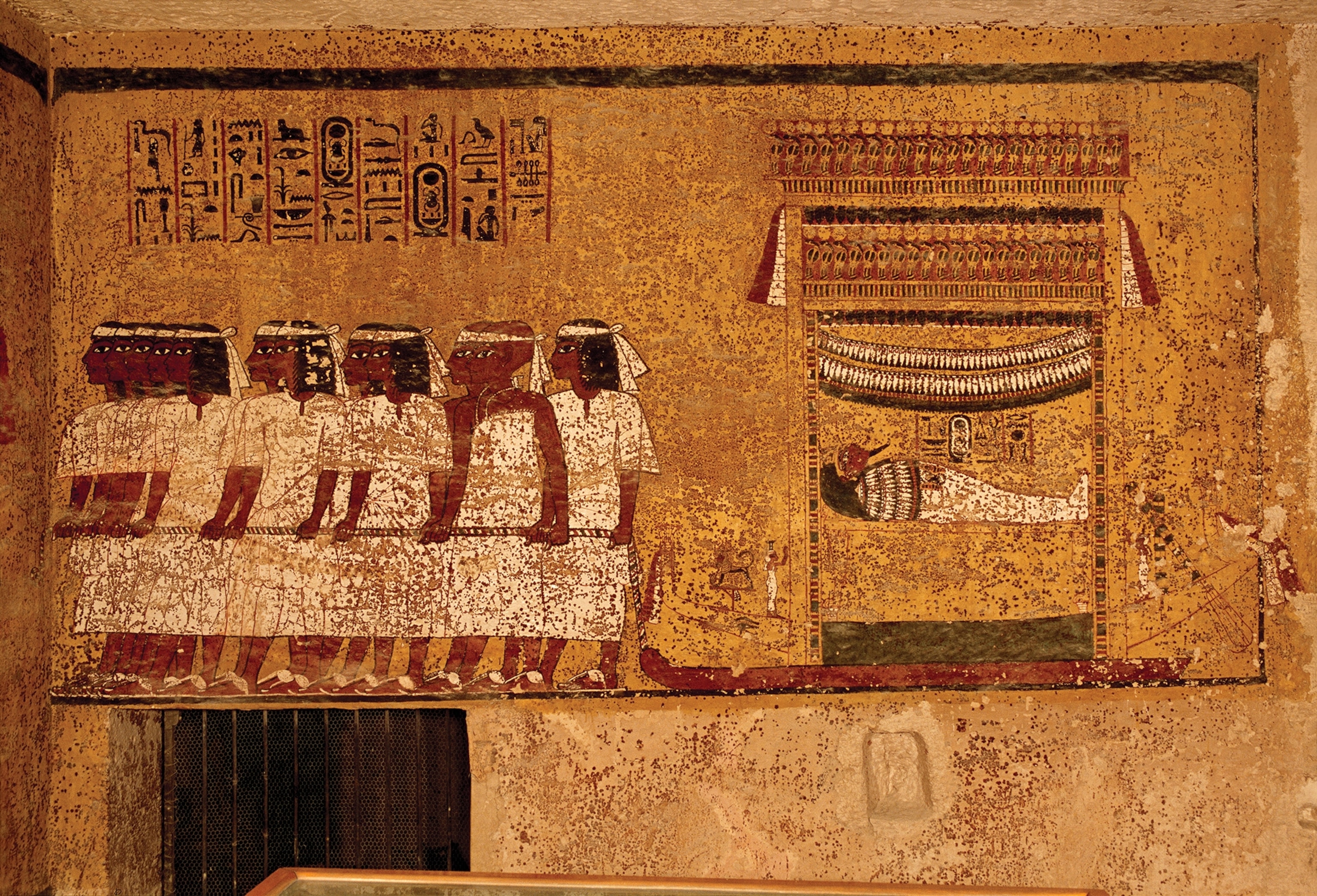 Illustrated on the east wall of the tomb is Tut's mummy lying on a funerary shrine pulled by mourners dressed in white.