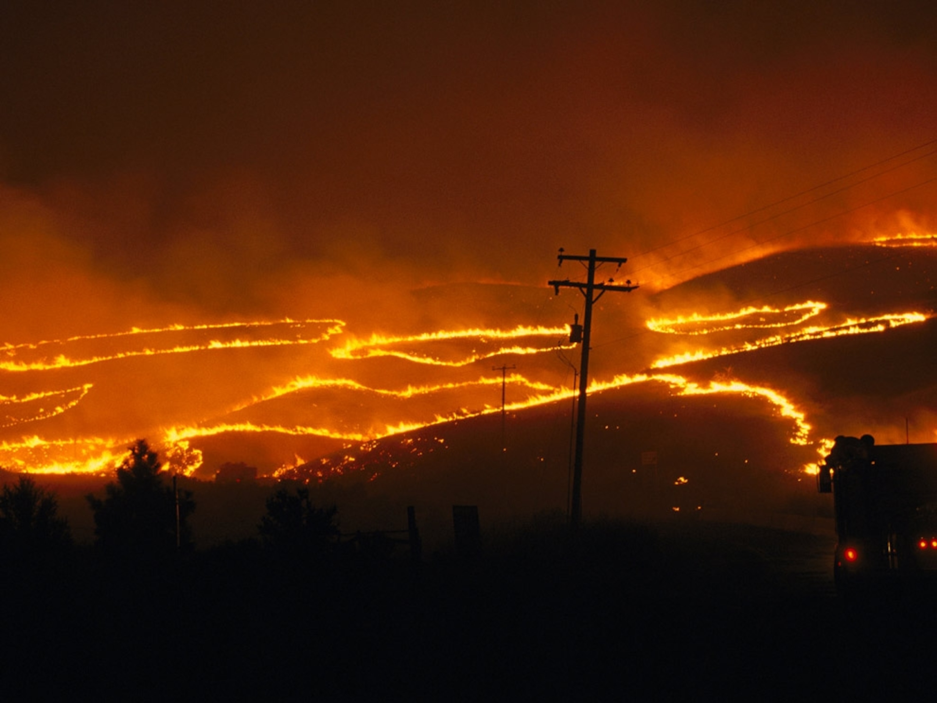 Lines of wildfire snaking through foothills