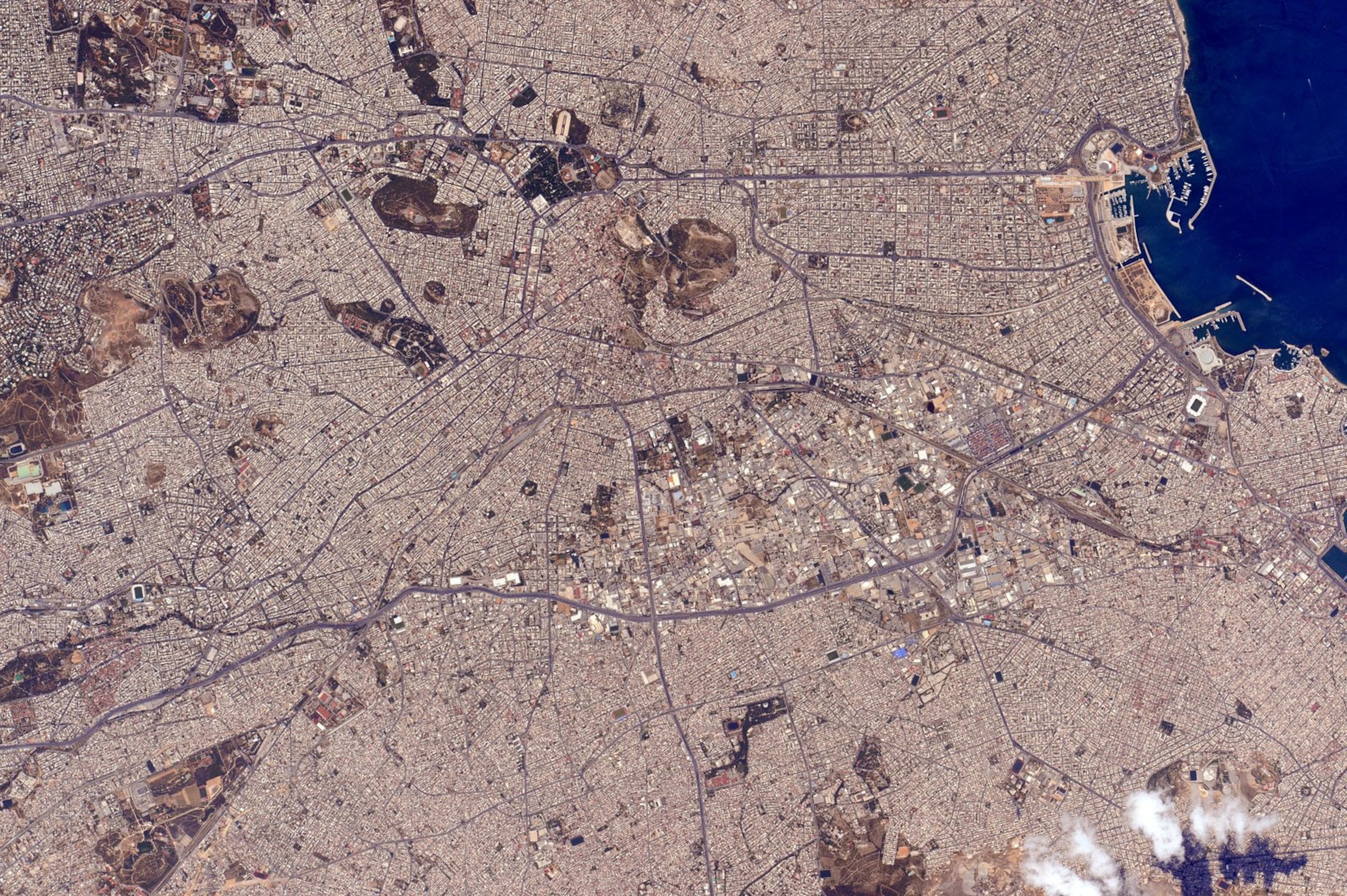 the aerial view of a densely populated coastal city region