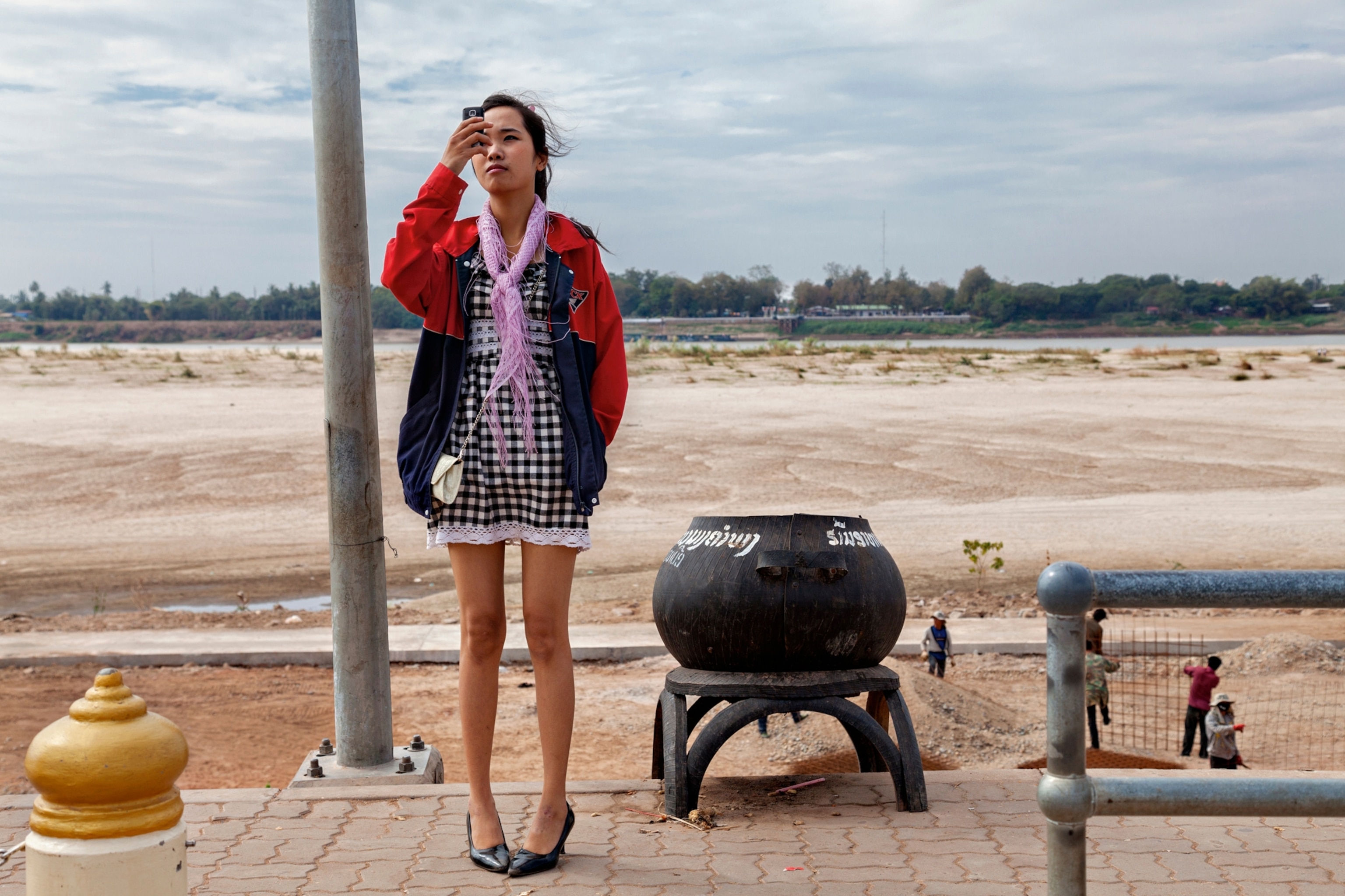 a Laotian girl holding a smartphone