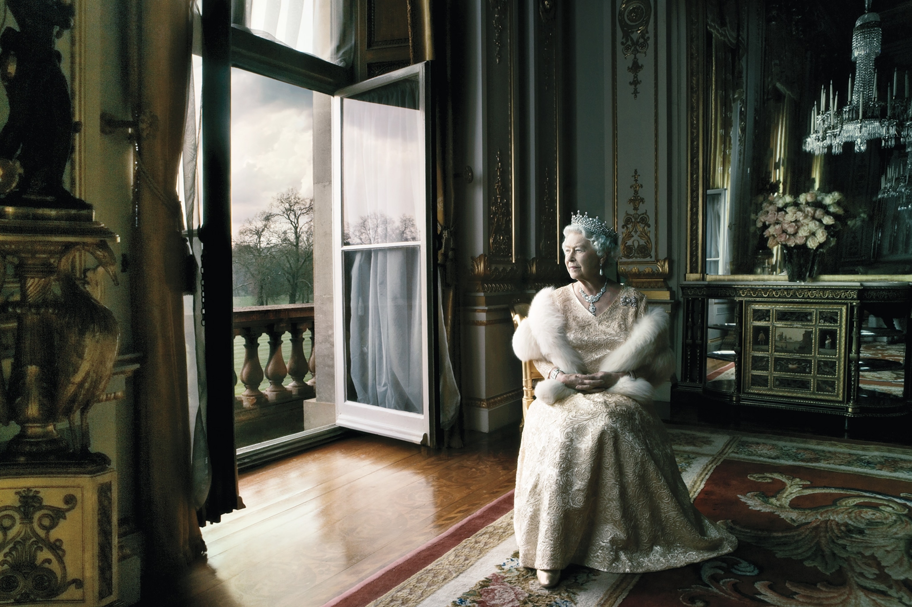 Queen Elizabeth sits in Buckingham Palace