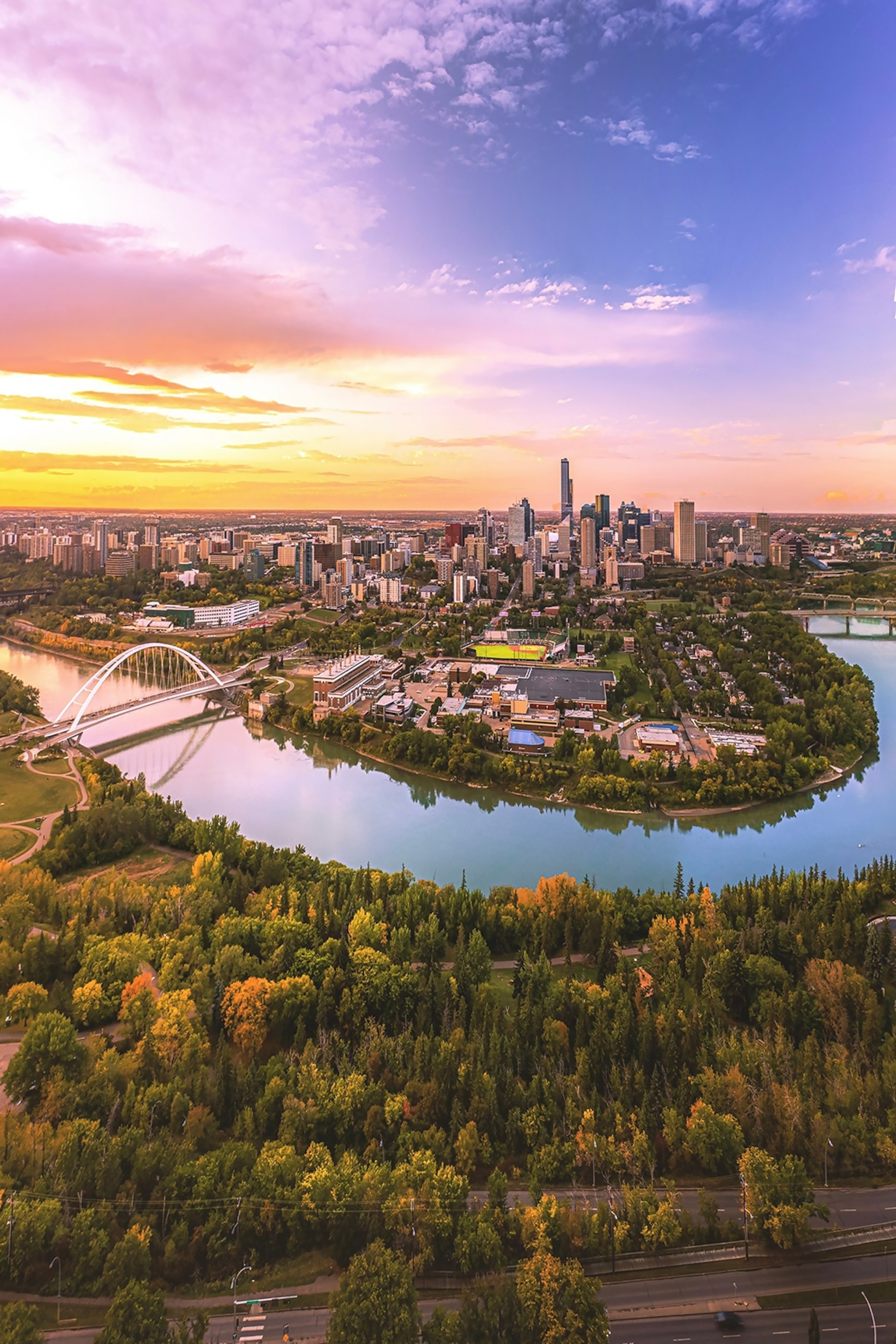 A bridge leads over a river to the downtown centre of Edmonton.