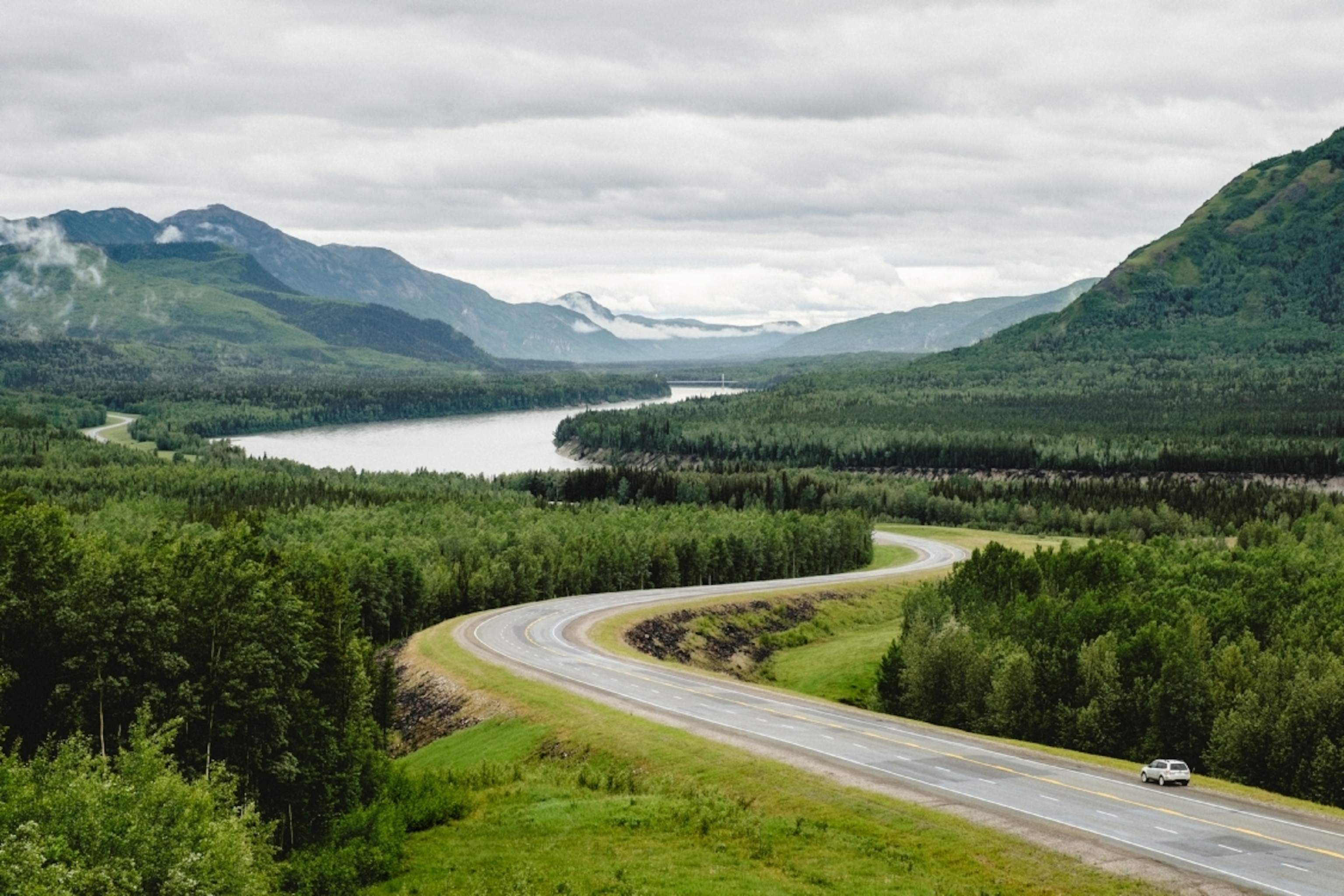 a car on its way along the Liard Valley, Alaska Highway