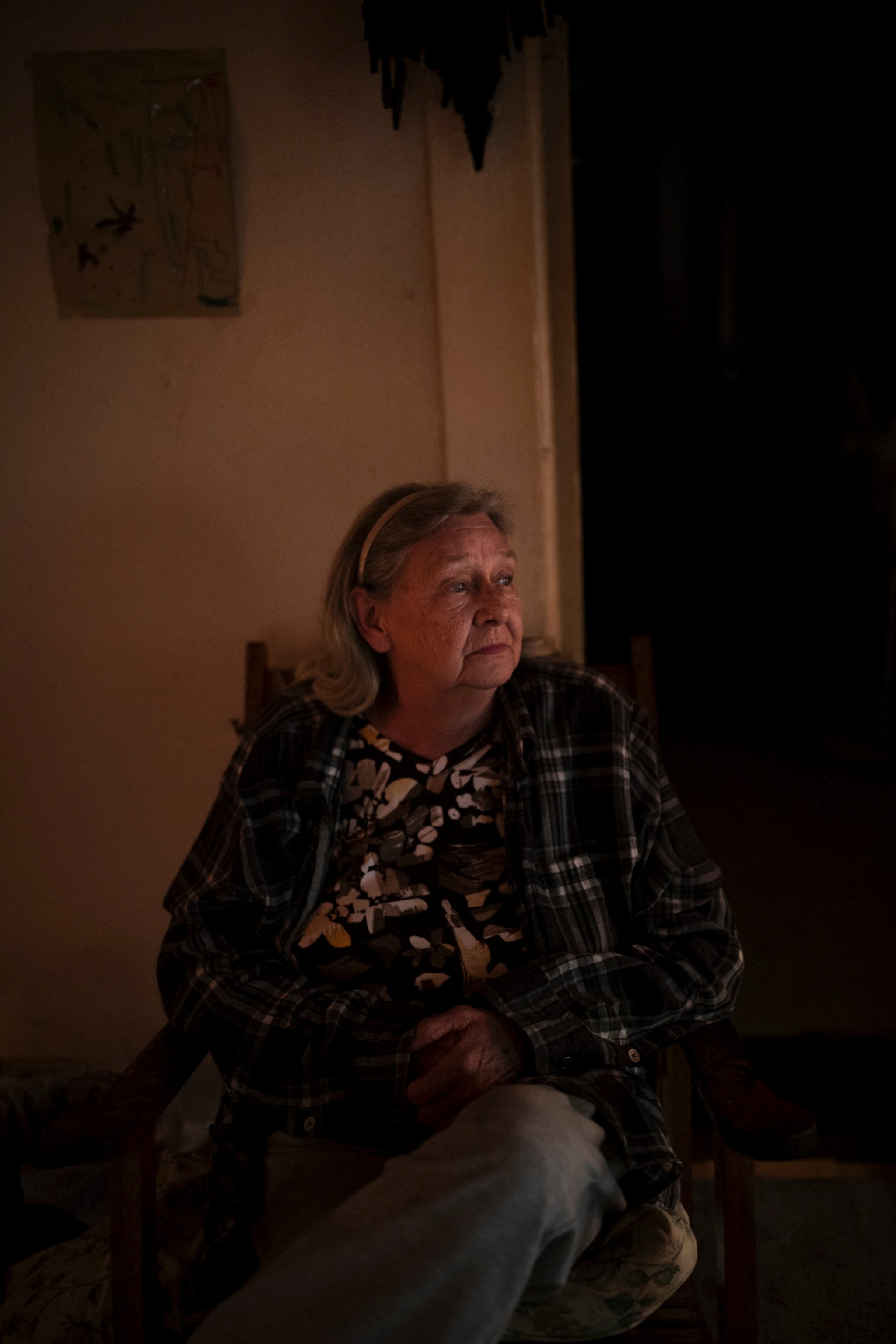 a woman sits inside her home in West Virginia