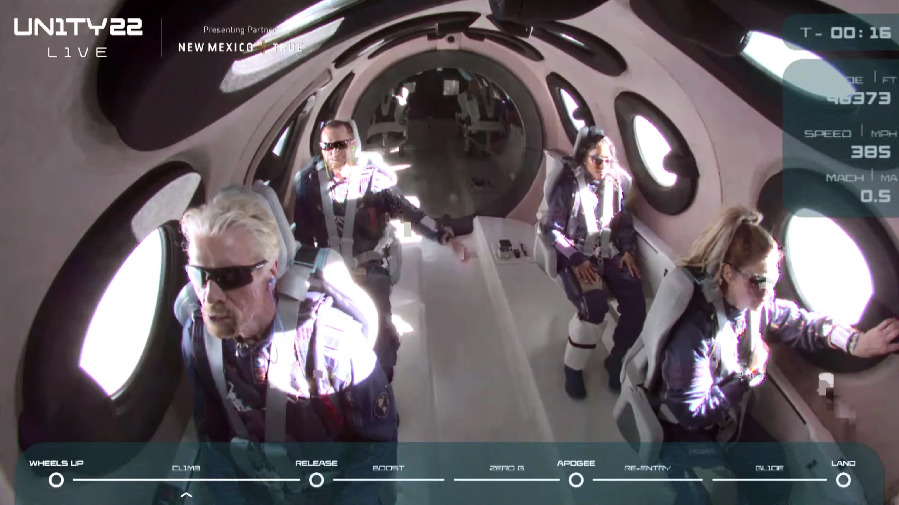 Virgin Galactic's Richard Branson and other passengers wait for the VSS Unity, Virgin Galactic’s sub-orbital rocket-powered space plane, to be released from the mothership.