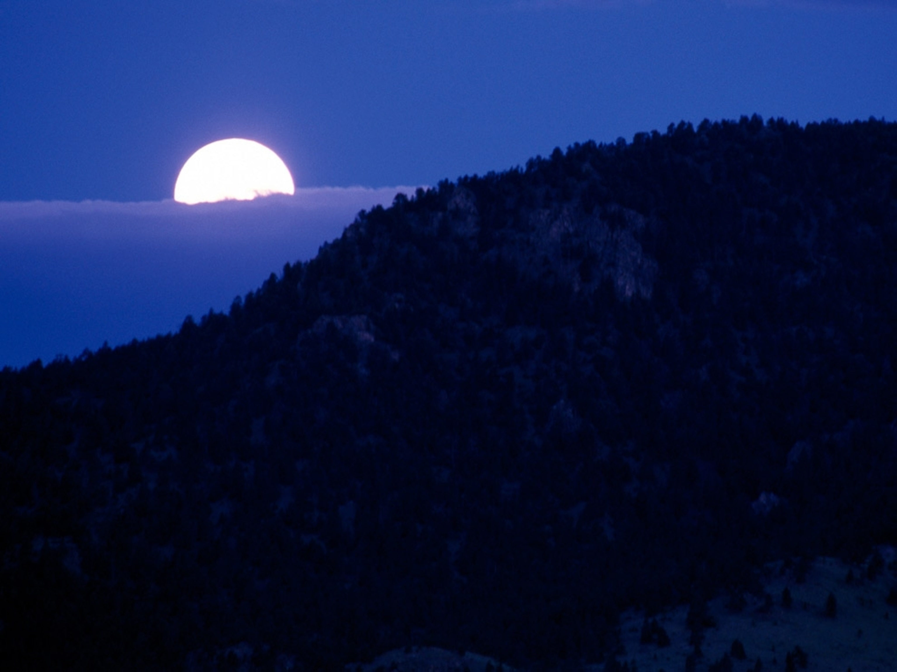 Yellow moon above clouds