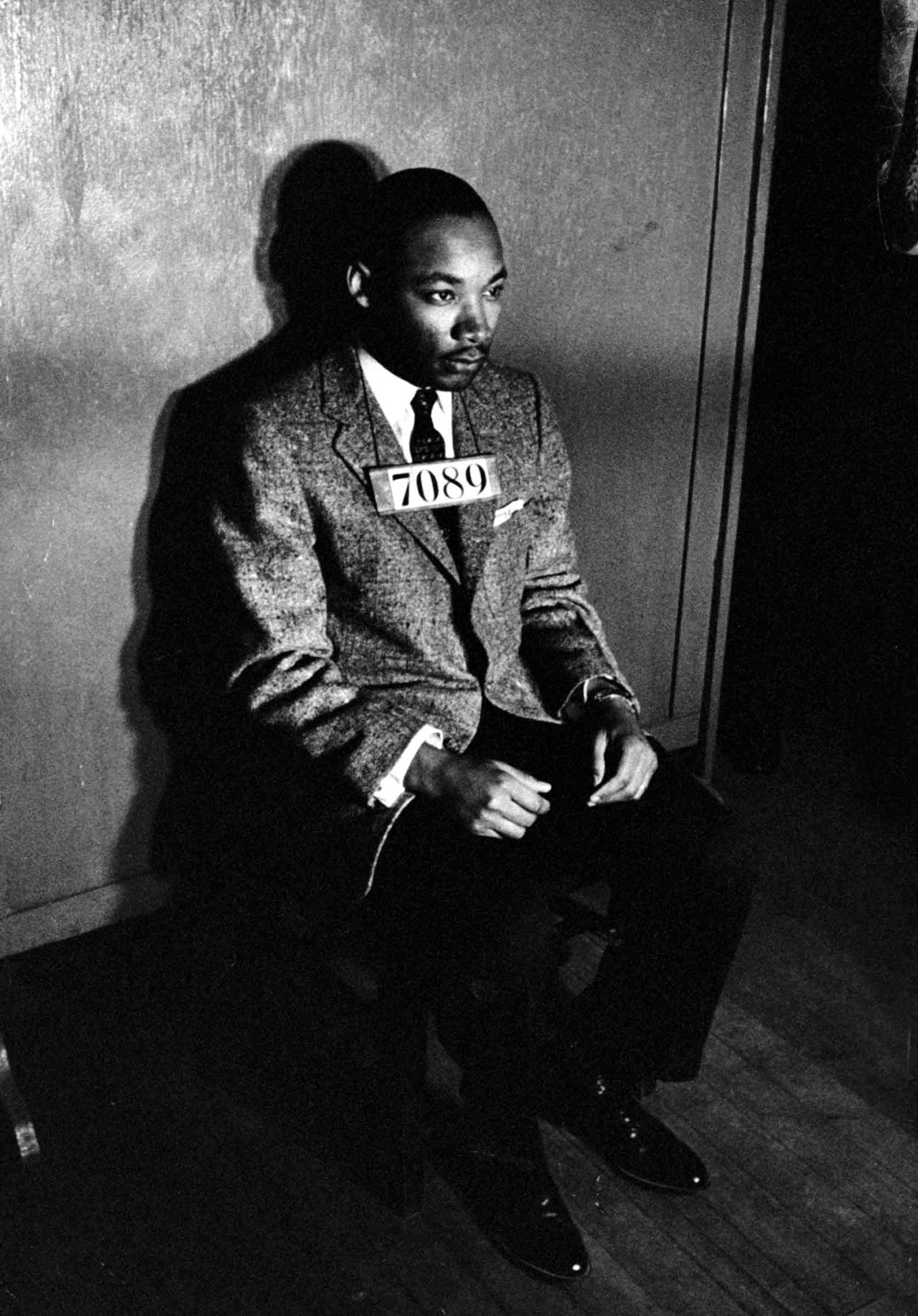 Martin Luther King Jr. sitting for a mug shot