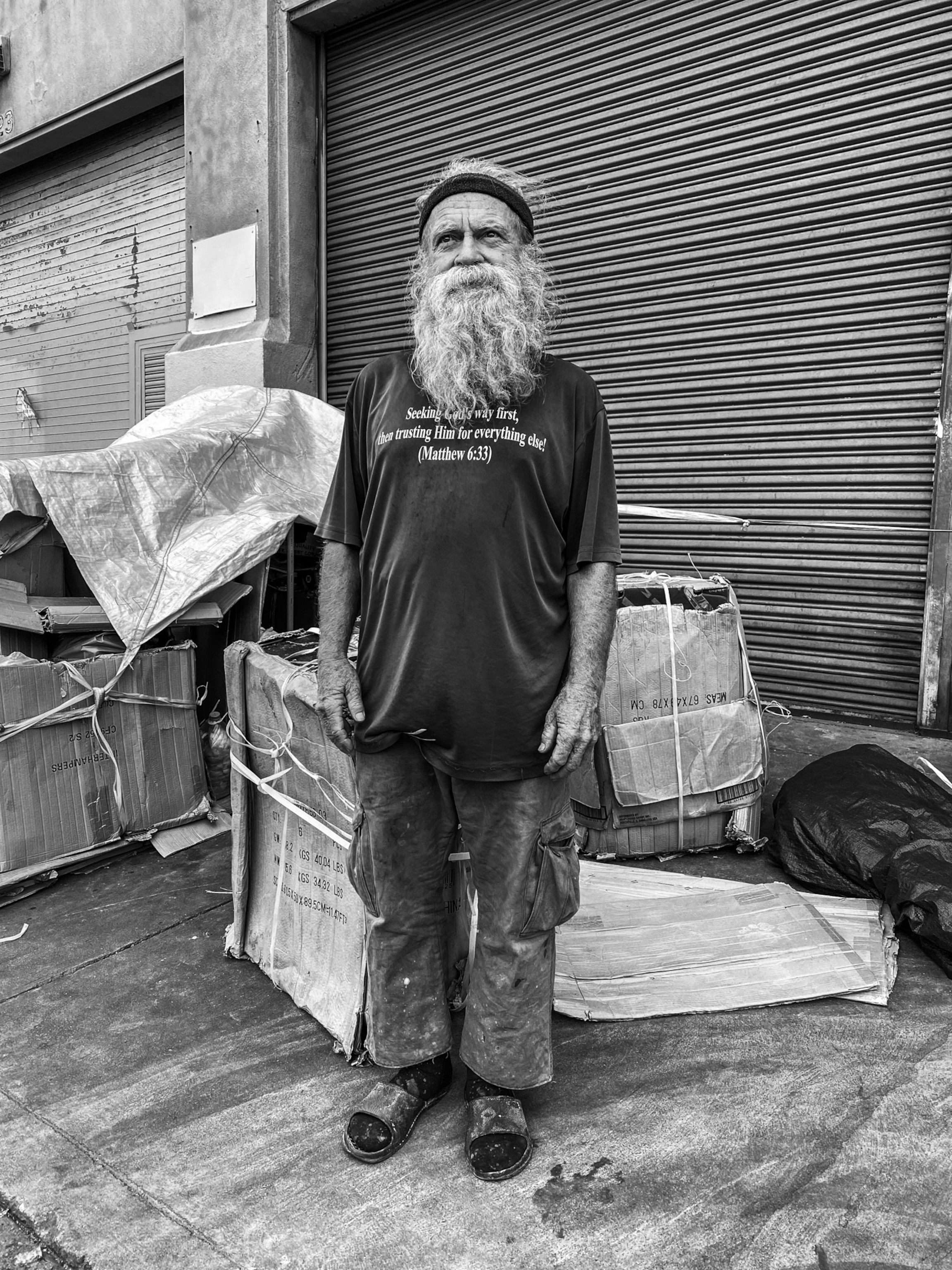 a bearded man standing for a portrait