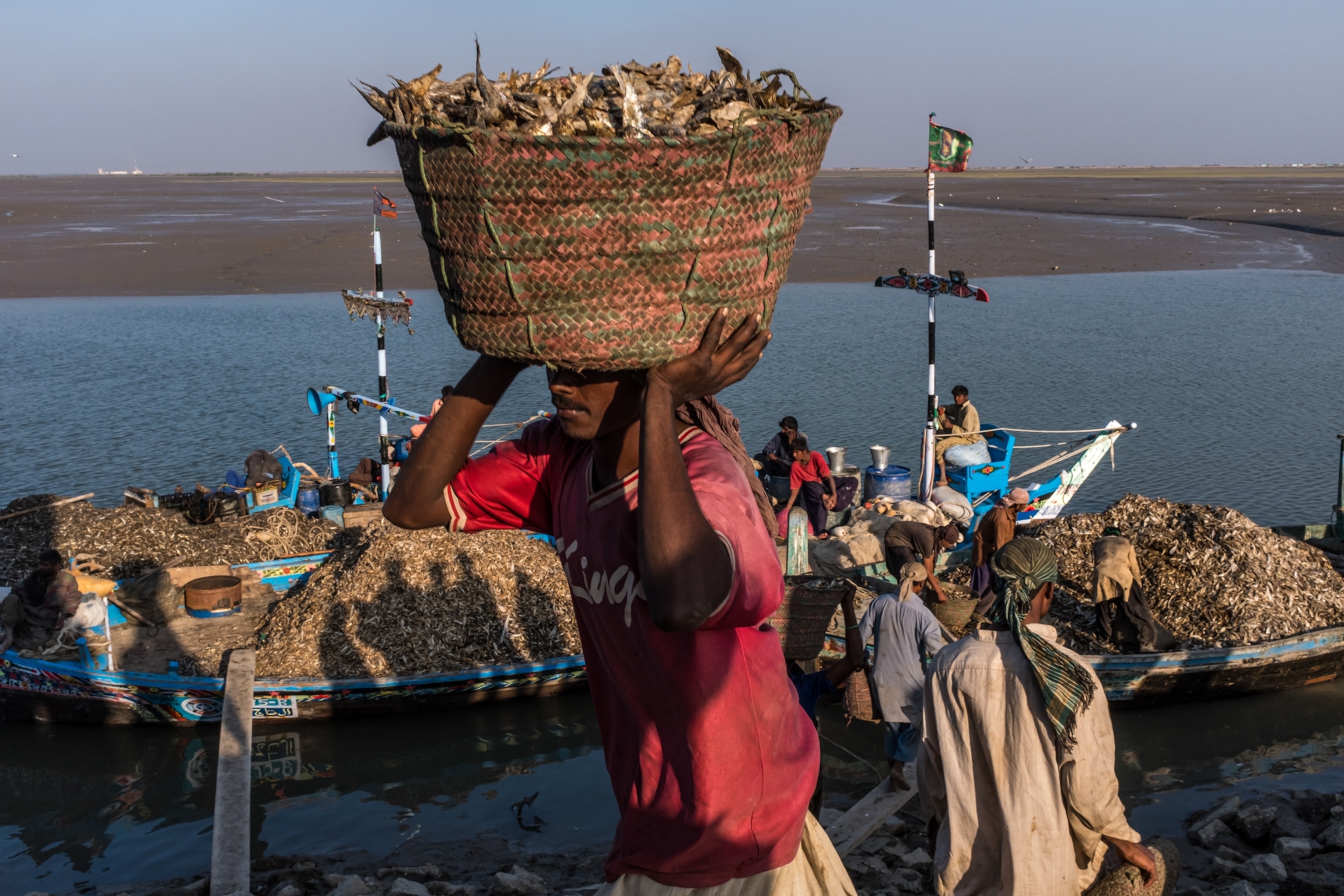a man carrying a basket of fish