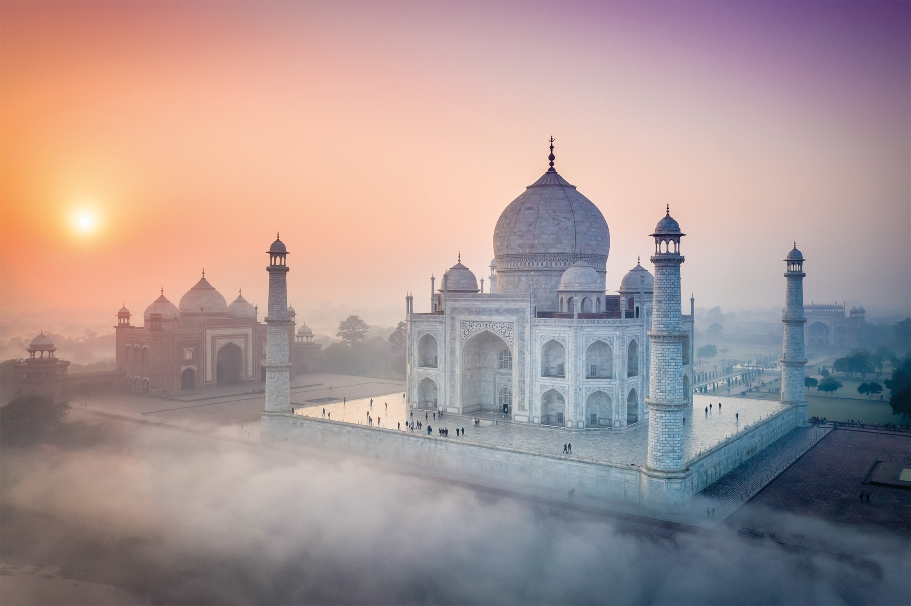 The marble of the Taj Mahal changes color as the light falling on it brightens and fades throughout the day. In this image, taken at sunrise, the building takes on a rosy hue.