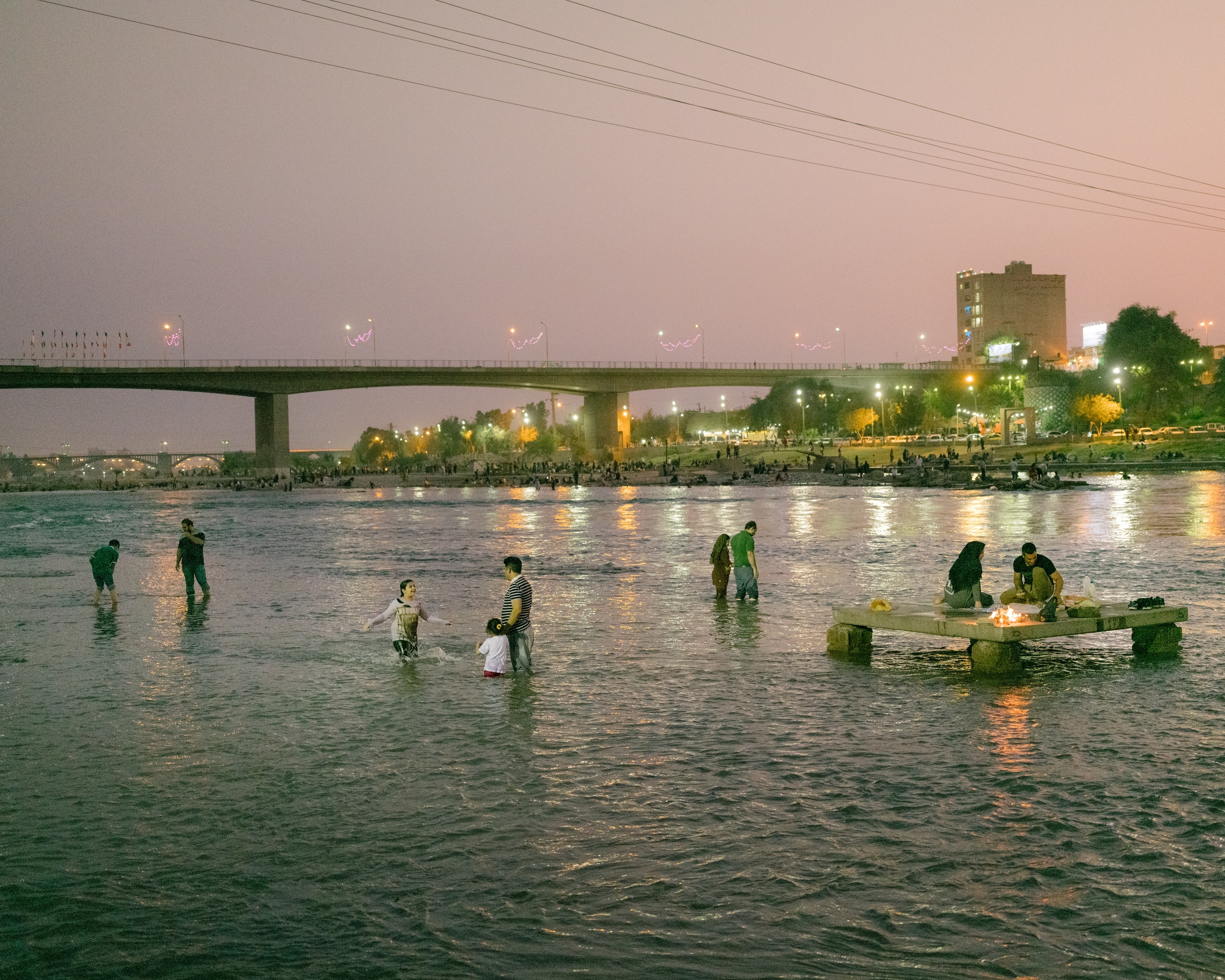 Families and friends gather for picnics at night along the relatively cool Dez river.