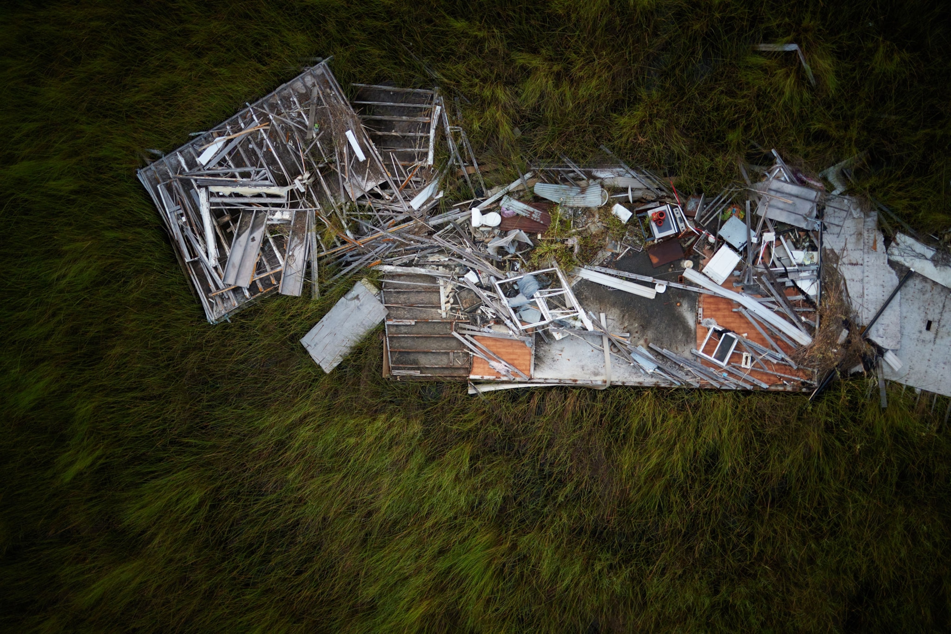 The remains of a mobile home in the marsh, that was destroyed by a hurricane.